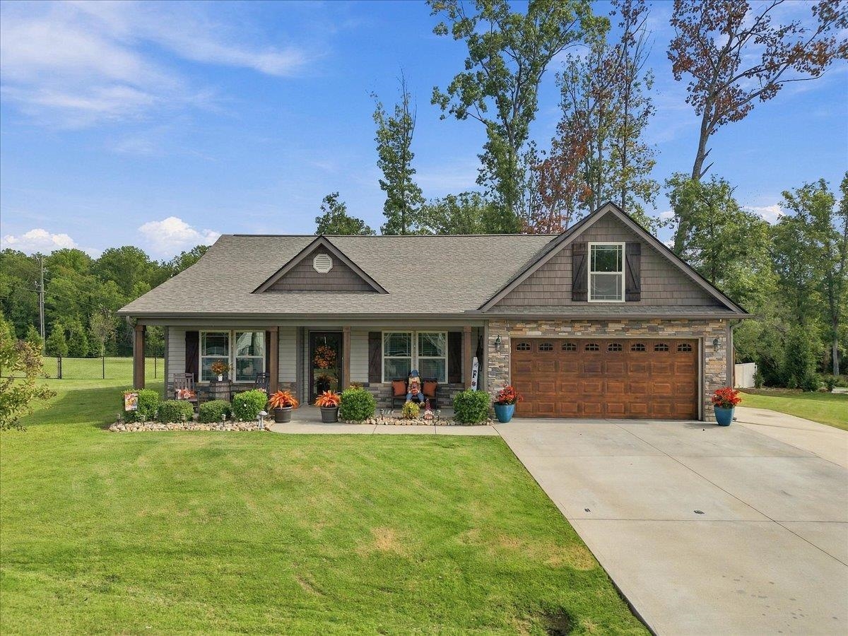 No HOA! Welcome to 229 Bertha Burns Road in Inman! Enjoy the lake lifestyle without giving up the space and comfort of home. This beautifully maintained property offers a spacious yard, attractive curb appeal, and an outdoor setup made for relaxing and entertaining—all just moments from the water. Inside, you’ll find a bright, inviting floor plan with comfortable living spaces and generously sized bedrooms. The spacious primary suite features a tray ceiling, plenty of room for a king-size bed, and a private bath complete with a double vanity and jetted tub. Additional bedrooms provide flexibility for family, guests, a home office, or hobby space. Step outside and you'll quickly see what makes this property special. The covered back patio creates the perfect spot for morning coffee, game days, or evenings around the fire, while the additional outdoor entertaining area, mature landscaping, fenced backyard, add even more functionality. The attached two-car garage and wide driveway provide plenty of parking. Aerial views showcase just how close you are to the lake, giving you the opportunity to enjoy the laid-back Upstate lifestyle while still being conveniently located to Boiling Springs, Inman, and surrounding areas. If you've been searching for a well-kept home with plenty of outdoor living space and a location near the water, this is one you won't want to miss!
