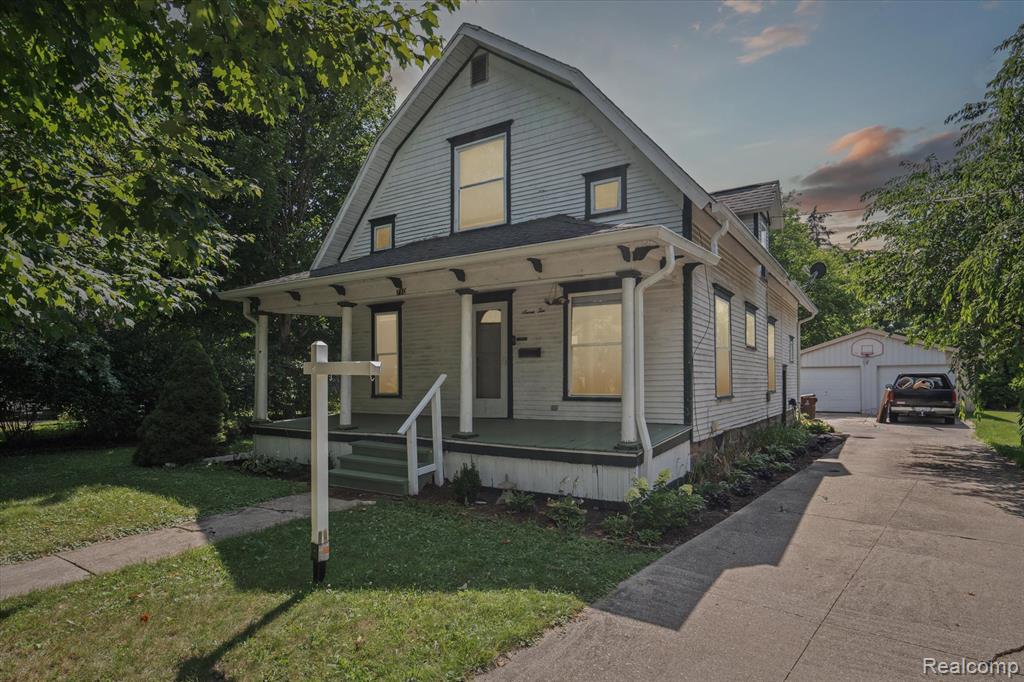 This charming 4-bedroom home boasts modern amenities and a delightful blend of classic and updated features. As you enter, you'll be greeted by original wood floors and a spacious front porch, setting an inviting tone. The kitchen has been refreshed with newly installed flooring and is equipped with oak cabinets and ample counter space. Convenience is key, with a first-floor laundry room and a bedroom for easy access. Upstairs, you'll find generously sized bedrooms with fresh carpet. The home is equipped with a high-efficiency furnace and air conditioning, ensuring comfort year-round. Located just a 10-minute walk from downtown, this home offers both charm and convenience.