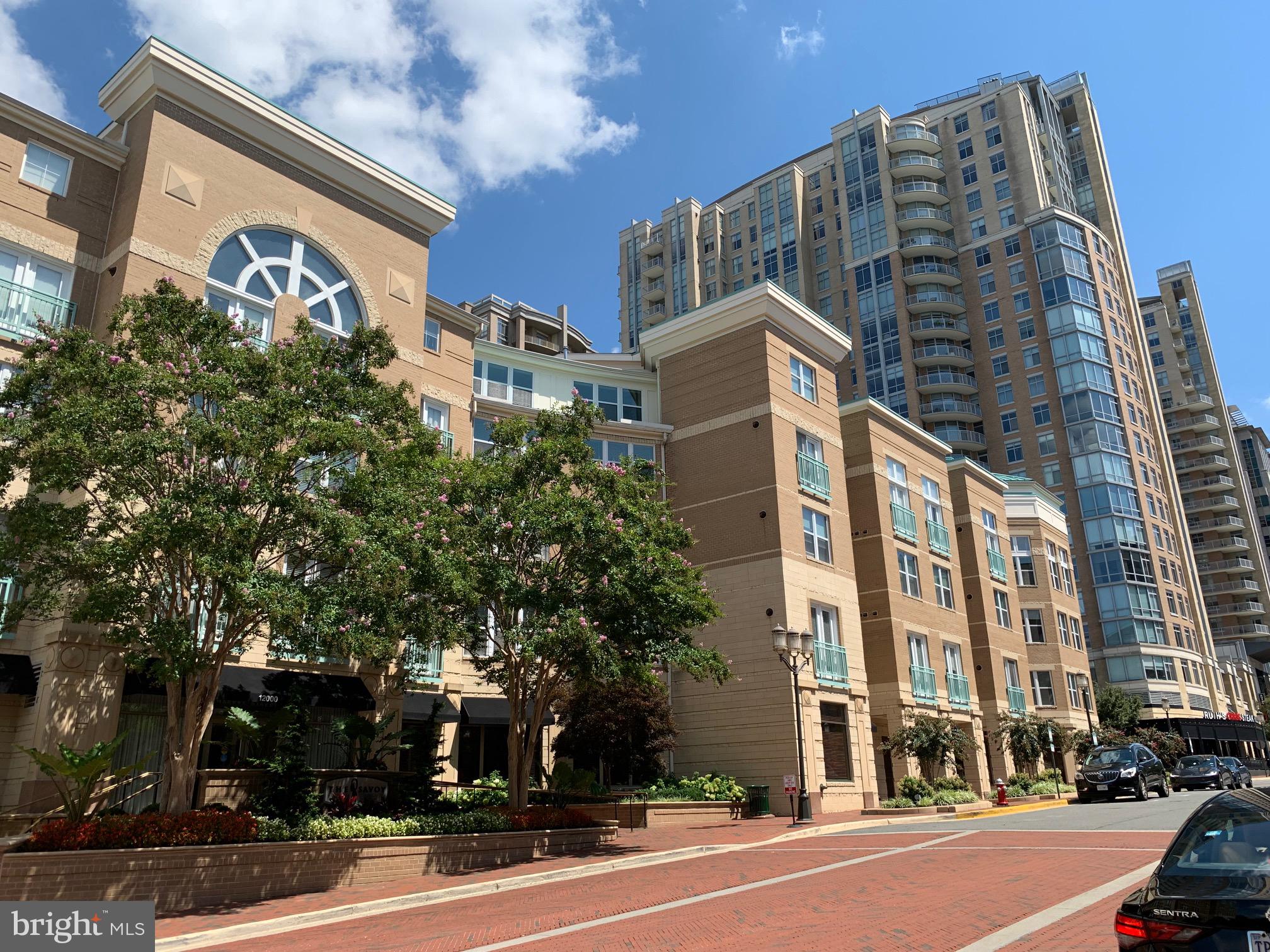 Looking for a beautifully maintained condo? Check out this lovely two-level penthouse at The Savoy at Reston Town Center. To begin, the two-level top floor penthouse offers a vaulted living room with a ceiling that reaches a 17-foot peak. In addition, the penthouse features a modern, granite kitchen with GE Profile stainless steel appliances. In the vaulted ceiling dining area, the adjacent living room competes with the crackle of the fireplace. The main level offers a well-appointed primary suite with a walk-in closet, an en-suite bath with walk-in shower, and a laundry area with a dryer. Bright, sunny den/office or potential 3rd bedroom. Balcony with room for table and chairs. A stairway nearby leads to a private second bedroom and bath on the second floor. Enjoy resort style amenities, concierge service, a fitness center, game room with billiards, and party rooms for hosting. Two assigned garage spaces, one of which may have room for a car and a motorcycle. Additional features include an updated main-level bath, an HVAC system, and water heater. Enjoy resort style amenities, concierge service, a fitness center, game room with billiards, and party rooms for hosting. Walk out your door to dining, shopping, seasonal events, the ice skating pavilion, the W&OD Trail, and the Reston Town Center Metro Station.