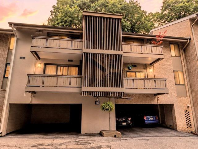 Rare opportunity to own a top-floor condominium in a beautiful park-like setting with tranquil tree views. This bright and inviting home features an updated kitchen and bathroom, hardwood floors, a private balcony, and the convenience of an in-unit washer and dryer. Additional storage is included, along with deeded covered parking located directly beneath the building, providing protection from rain and snow year-round. Residents enjoy exceptional community amenities, including swimming pools, tennis courts, scenic walking trails, and a charming village atmosphere with nearby cafés and shops. A perfect combination of comfort, convenience, and lifestyle.