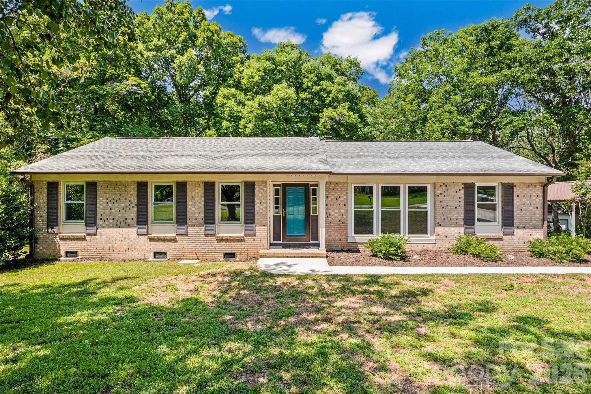 Rock Hill...Welcome home to this recently remodeled 3-bedroom ranch, offering modern updates and move-in-ready convenience! Recent improvements include new quartz countertops, a new kitchen range, energy-efficient new windows, a new Trex deck, and a large custom concrete raised patio. Bathrooms have been updated with new tile, mirrors, new sinks and faucets, new ceiling fans, and fresh interior paint, creating a bright, inviting atmosphere throughout. The exterior features a classic brick front with low-maintenance vinyl siding, a detached two-car carport, and a generous .58 acre lot with plenty of outdoor space to enjoy. An additional outbuilding, wired for power but not currently connected, provides excellent potential for storage, a workshop, or hobby space. With so many thoughtful upgrades already completed, this home offers a blend of comfort and style. Easy access to shopping and restaurants nearby, and access to I-77.