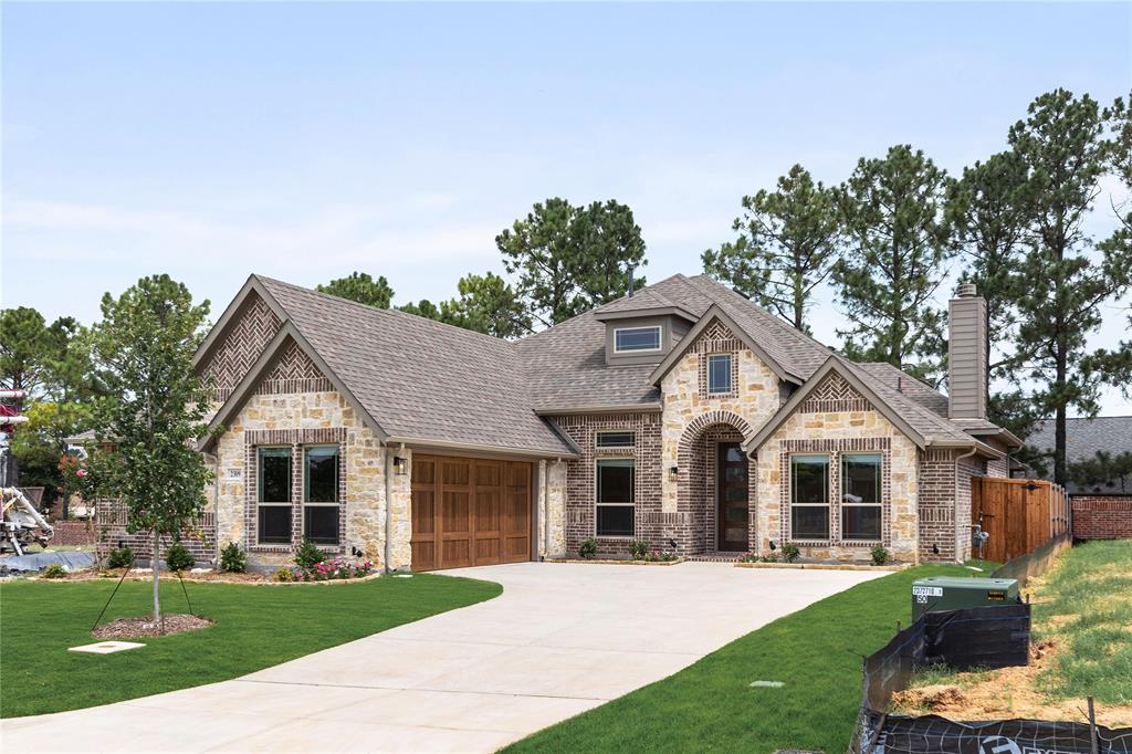 NEW! NEVER LIVED IN. Ready to Close. Welcome to Grace Park, Bedford’s newest and most sought-after community, where modern design meets everyday comfort. This stunning Bloomfield Homes Rockcress plan offers 3 bedrooms, 3 bathrooms, and a thoughtfully designed layout filled with high-end finishes and elegant details throughout. Give Bloomfield Homes a call to learn more about this special home! From the moment you arrive, the home’s striking brick and stone façade creates exceptional curb appeal, complemented by upgraded cedar garage doors and exterior lighting that enhances its architectural charm. Step inside to discover beautiful engineered wood flooring flowing seamlessly through the main living areas, setting the tone for a warm yet sophisticated interior. Just off the entry, a private study with glass French doors provides the perfect space for a home office or flex room. A conveniently located half bath adds functionality for guests. The spacious living room is the heart of the home, filled with natural light and anchored by a dramatic floor-to-ceiling stacked ledgestone fireplace—ideal for both relaxing evenings and entertaining. The deluxe kitchen is designed to impress, featuring a large center island with quartz countertops, abundant cabinetry, and a generously sized walk-in pantry. Whether hosting gatherings or preparing everyday meals, this space combines style and practicality effortlessly. Tucked away at the back of the home for added privacy, the primary suite offers a peaceful retreat. The ensuite bath includes an enlarged walk-in shower, a dual sink vanity, and ample space to unwind and recharge. At the front of the home, two additional bedrooms share a well-appointed full bath, creating a comfortable layout for family or guests. This home truly blends luxury, comfort, and functionality in a prime Bedford location. Don’t miss your opportunity to own in Grace Park—schedule your tour today and experience everything this exceptional home has to offer!
