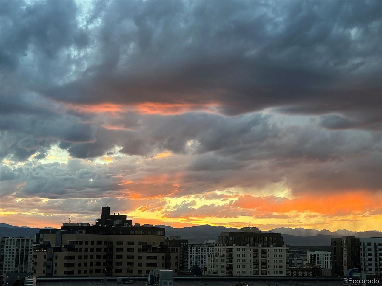 Beautifully updated penthouse condo flaunting magnificent views of the Front Range, downtown Denver, and Colorado's expansive blue skies. Offering more than 2,000 square feet of luxurious living space, this exceptional home features a chef's kitchen with a rare gas range, generous island, oversized refrigerator, and pantry. Two en-suite bedrooms complement a bright, skylit living area that seamlessly connects the dining room, living room, and family room. The Primary bathroom's proximity to the glass windows brightens the space with the natural light again an almost never found perk in Condo living. The open floor plan extends to a wraparound balcony-perfect for grilling, entertaining, or simply enjoying the Colorado outdoors. Gleaming hardwood floors bring warmth and sophistication, while two wood-burning fireplaces can be enjoyed from the primary bedroom and the inviting living room. Custom cabinetry throughout includes a built-in entertainment center, wet bar, bench seating with storage, and extensive office cabinetry. The private office also features a pocket door, a separate air handler for added cooling, and ample space for additional shelving-ideal for working from home or creating a personal library. Storage is abundant, with two separate storage areas, two walk-in closets, a large sliding-door closet, and a kitchen pantry. The residence also includes two deeded parking spaces. Ideally situated in Capitol Hill, the home offers convenient access to public transportation, the Cherry Creek Trail, downtown Denver, and Cherry Creek shopping and dining.