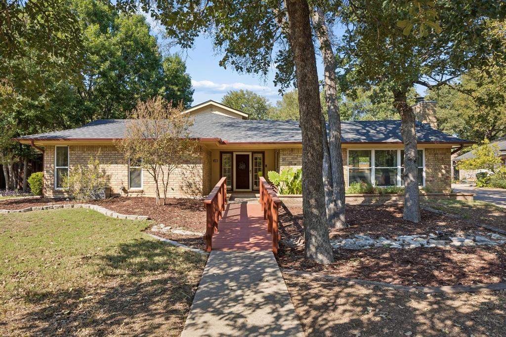 Located in the heart of Bedford within the highly sought-after HEB ISD, this charming, move-in-ready home offers three bedrooms and three full baths. Inside, natural light brightens the common areas, while the oversized family room features a wood-burning brick fireplace framed by built-in shelving and surround sound wiring, creating a warm and inviting space for relaxing or entertaining. The dining room showcases distinctive architectural character with brick accent walls, vaulted ceilings with exposed beams, and skylights that flood both the dining room and kitchen with natural light, creating a bright and inviting setting for everyday meals and gatherings. The kitchen also features a reverse osmosis system with a dedicated filtered water faucet.Outdoor living is equally inviting, with privacy fencing surrounding a covered patio and private outdoor area. A generous backyard with mature trees and a storage shed offers plenty of space to relax, entertain, or play. Additional highlights include an extended driveway, extra parking, and a two-car side-entry garage. Conveniently located near local parks, shopping, dining, and major highways for an easy DFW commute. Recent updates include HVAC replacement in 2020, roof replacement in 2024, and a new side-yard fence and entry bridge in 2026. Schedule your showing today!