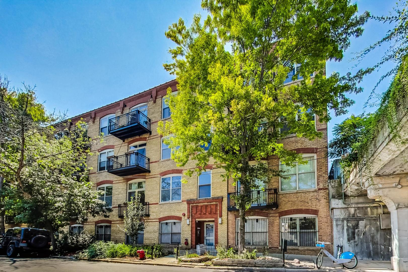 Welcome to Buck City Lofts! Large, beautifully updated 1 bed/1 bath condo perfectly situated just steps from the 606 Trail! This sun-drenched condo features exposed brick, soaring timber ceilings, massive windows, and a large private balcony with east-facing views. Newer high end flooring throughout, and a fully updated kitchen with large kitchen island, white calacatta countertops, and stainless steel appliances, that opens into a wonderfully sized living and dining space. Bedroom can accommodate a king sized bed, and includes a huge walk in closet. Other features include in-unit laundry, coat closet, utility closet, and linen closet in the bathroom. The building features common rooftop deck with stunning 360 degree views, bike storage, shared storage, high-speed Google fiber internet, convenient Butterfly entry system, and an attached garage. Located conveniently the heart of Bucktown and walking distance to the Western Blue Line, local retail, restaurants, nightlife and endless entertainment options. 1 covered garage parking spot included in the price.