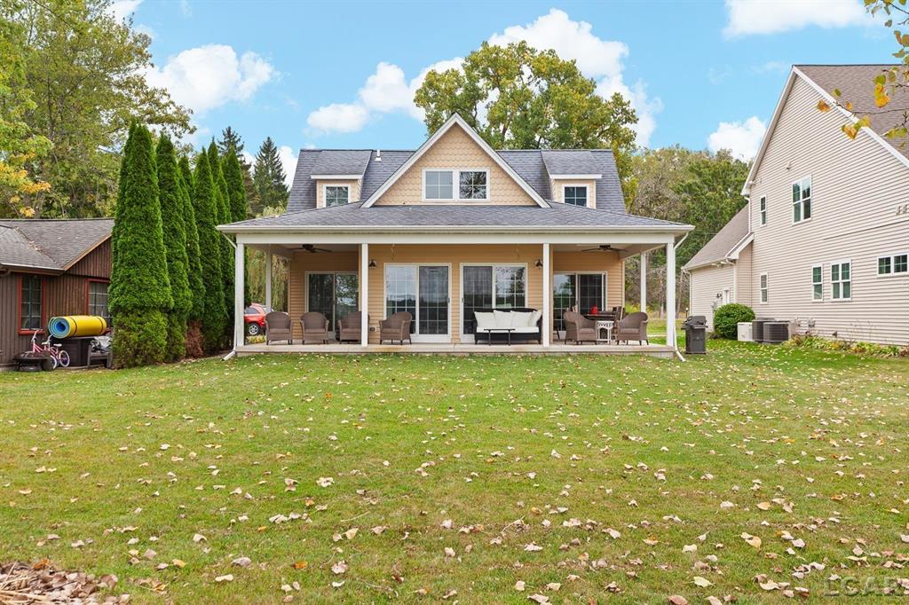 Devil's Lake Waterfront Home with 80' of beachfront property. This gorgeous lakefront home features 1700+ sq. ft of living space with 3 BD 1-1/2 BA offered fully furnished is beautifully maintained inside and out.  Hardwood floors throughout with soaring ceilings and walls of windows for natural light.  Open concept kitchen with solid surface countertops and large island seating for gathering.  The dining and living room overlooking beautiful backyard space for all the activities, with no stair steps to the waterfront.  Main floor master bedroom with private patio and views of the lake.  Upstairs features two bedrooms, 1/2 bath and loft area with built in day bed and pull-out queen bed sofa for additional sleeping options.