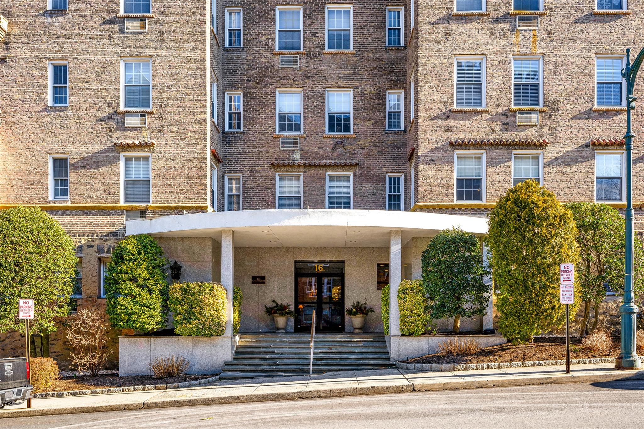 Welcome to The Chatsworth, Larchmont’s prestigious pre-war, full-service doorman building with deeded parking. This beautifully updated, sun-drenched two-bedroom, two-bath apartment on the sixth floor is a rare find. Renovated in 2020, both the kitchen and bathrooms offer modern finishes and stylish upgrades.
The spacious layout features large rooms and abundant closet space, creating a functional and inviting home. A generous foyer leads to a bright, open living room with a dedicated dining area. Gorgeous hardwood floors run throughout, and a wall of windows floods the space with natural light, offering spectacular sky views.
The primary suite is a peaceful retreat, bathed in morning sunlight and overlooking the tranquil courtyard. It includes three large closets and an en-suite bath with a step-in shower. The second bedroom is equally spacious, filled with light, and has two large closets. The second bath features a tub with a glass enclosure and natural light.
The chef’s kitchen is a standout, with sleek stone countertops, a glass tile backsplash, stainless-steel appliances, and ample cabinetry. A utility closet provides extra storage.Located just north of Larchmont Village, you’re steps from Metro-North, local shops, restaurants, parks, and the Saturday Farmer’s Market. Building amenities include parking, a fitness room, bike storage, and additional storage. This rare offering in the heart of Larchmont is not to be missed!