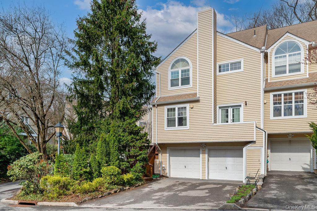 Spacious Hartsdale Townhome!  This bright and spacious end unit features a gas fireplace, 2 car garage, central air conditioning, deck, patio and lives like a 3-4 bedroom home.  The eat in kitchen, primary bath and powder room have all been tastefully updated. Unit boasts abundant storage, cathedral ceiling in primary bedroom & walk in closet. Large third floor loft also has a spacious walk in closet.  Lower level features recreation room/family room with sliding glass doors to the patio.  Perfectly situated for convenience, enjoy proximity to Hartsdale Metro North Station, express bus routes to NYC, as well as local shopping and dining options. A true commuters dream.  Low HOA fees cover your exterior maintenance, landscaping and snow removal. Don't miss this opportunity!