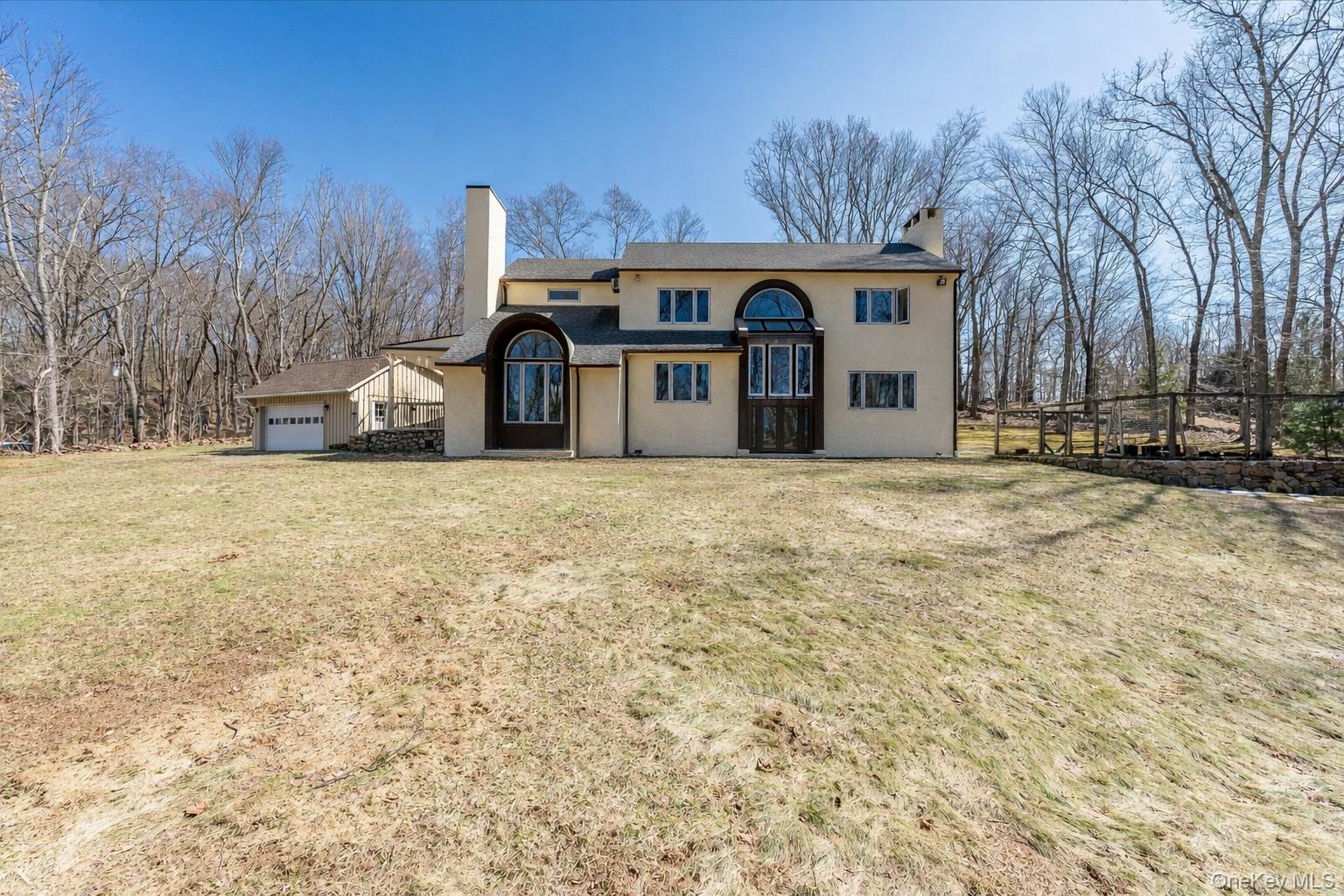 This private and spacious home sits on 2.5 acres of beautiful land in Pound Ridge, and is the ideal Westchester retreat. It has that perfect mix of "peace and quiet" without being completely off the grid. With 4 bedrooms and 3 full bathrooms, you’ll have plenty of room for everyone. The versatile floor plan offers endless possibilities to make the space your own. Enjoy a bright eat-in kitchen with skylights that fill the room with natural light—perfect for morning coffee. The large quartz-topped island is perfect for meal prep and entertaining, and features a gas cooktop. A wood-burning stove in the den is cozy and warm on cold nights. Large windows throughout the home create a light and airy atmosphere. This home features an elegant formal dining room—perfect for hosting holiday feasts and candlelit dinner parties. The living room centers around a classic fireplace, offering a warm, relaxing retreat for evenings at home. An unfinished space just off the living room offers exciting potential. Createa sunroom, screened-in porch, home office, or additional living area tailored to your vision. The newly built two-car garage (2022) provides ample storage. New roof in 2025. Whirlpool dishwasher 2021, Stove top on Island 2023, Oven and in-wall microwave 2020/2021. GE Refrigerator 2023.