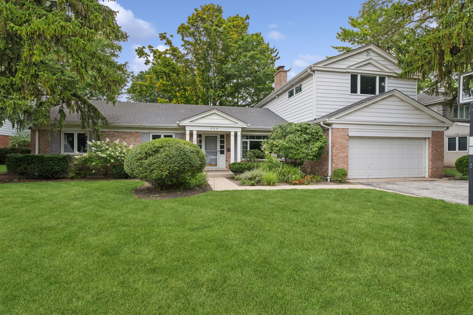 Looking for one-level living in Wilmette? A first-floor primary suite anchors this spacious 4-bedroom, 3-bath home that lives like a ranch. A gracious formal living room welcomes you with hardwood floors and a wood-burning fireplace. The kitchen shines with quartz countertops, an abundance of cabinets, Bosch, Sub-Zero, and Dacor appliances, and opens to a flexible living space, with one room ready to serve as a dining room or den and another as a dining room or family room. Just beyond, a bright sunroom offers a light spot to relax, overlooking the private patio. The primary suite features an updated bath and two oversized walk-in closets, set in a private wing with two more main-floor bedrooms. Upstairs, a second-story addition delivers a fourth ensuite bedroom, a private retreat ideal for guests, in-laws, or a quiet home office. Convenient attached 2-car garage. Steps from parks, pool, and Wilmette's schools, all within walking distance. First-floor living, flexible space, unbeatable Wilmette location. Come see!