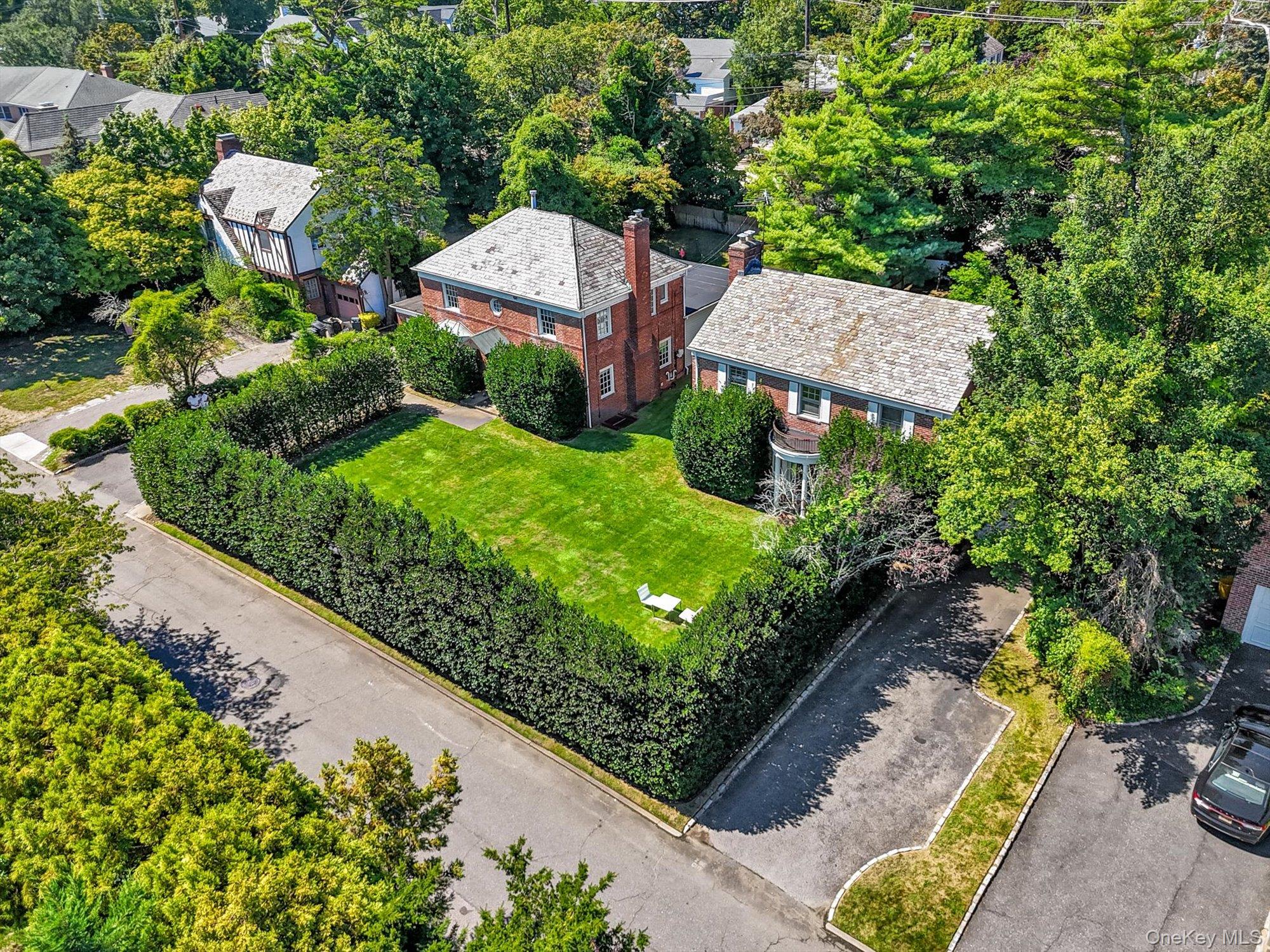 BOTH PROPERTIES ARE BEING SOLD TOGETHER AS ONE LISTING
30 & 16 Beechwood Drive, Sutton Park, Lawrence, NY  
An exceptional opportunity to acquire two neighboring properties in the highly sought after Sutton Park section of Lawrence. Together, 30 Beechwood Drive and 16 Beechwood Drive offer a combined lot size of approximately 140 x 135 feet, presenting endless possibilities for end-users, investors, or developers. The front of both homes features a beautiful large lawn surrounded by mature trees, giving the properties the appearance of having been designed to complement one another.
30 Beechwood Drive
This move in ready residence features 6 bedrooms and 4 full bathrooms. The layout includes three bedrooms on the upper level, one on the main floor, and two in the finished basement. Bathrooms are conveniently located with two upstairs, one on the main level, and one in the basement.
The home’s interior is designed in a sleek, modern white palette, evoking a gallery like aesthetic. A Bulthaup kitchen, outfitted with Gaggenau and Miele appliances, serves as the centerpiece of the home. Additional highlights include a spacious backyard with a half basketball court, perfect for recreation and entertaining.
16 Beechwood Drive
Located directly next door, this 4-bedroom, 3-bathroom home offers tremendous potential. The layout features one bedroom on the main level and three bedrooms upstairs, with one full bath on the main level and two full baths upstairs. The backyard includes an in-ground pool, offering a wonderful foundation for a personalized outdoor retreat. While the home does require renovation, it provides a unique opportunity for customization to suit your personal taste and lifestyle.
Property Dimensions
• 30 Beechwood Drive: Approx. 68 x 141 feet
• 16 Beechwood Drive: Approx. 67 x 140 feet
This rare side-by-side offering is ideal for those seeking a multi property purchase, extended family living, or redevelopment in one of Lawrence’s most desirable neighborhoods.