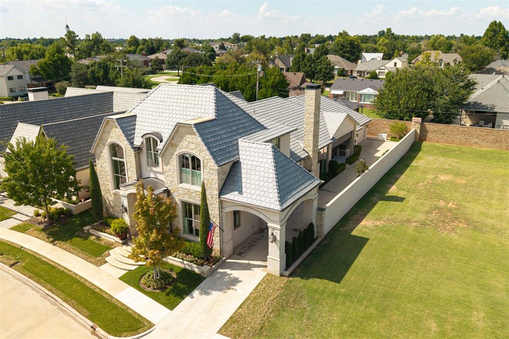 Perched on one of Nichols Hills’ most exclusive cul-de-sac streets, this French Country showpiece offers approximately 5,000 sq ft of curated, high-end living — with every detail dialed in. It's the ultimate lock-&-leave lifestyle in one of the most coveted enclaves. Grand symmetry, stucco & natural stone, a sweeping porte cochère, & magazine-worthy curb appeal set the tone for the design inside. Flexible floorplan has 4 bedrooms or 3 bedrooms plus a flex room (currently a quilting room), 3 living + office & bonus play/workout/media room. Herringbone white oak floors, soaring ceilings, and custom millwork anchor the living spaces, while the chef’s kitchen has Thermador appliances, a Galley workstation sink, Taj Mahal quartzite, custom Wood Mode cabinetry, built in vegetable steamer, & double ovens, each with convenient side-swing doors, coffee bar & a back-kitchen/scullery with pantry space + home-management station. The open living area has a cast-stone fireplace with 12' ceilings & 10' windows, & flows to the heated all-season patio with retractable screens, perfect for year-round entertaining. Motorized blinds on 10' windows offer effortless light & privacy control. The primary suite is a private retreat: heated bathroom floors, Esmeralda marble, and a custom Inspired Closets design that has all the bells & whistles. Additional highlights include a built-in dining room display cabinet with unexpected depth, a hidden nook in the pantry, abundant storage, a whole house Generac generator, DaVinci roof, & dual Tesla chargers in the garage. Cumberland Court HOA provides Nichols Hills only luxury concierge services including daily plant watering, handyman services, patio cleaning/pressure washing, mail/package services, weekly lawn maintenance and much more! Walk to Trader Joe’s & Starbucks, you're steps from Nichols Hills Plaza, Whole Foods & Classen Curve. Rare blend of privacy, convenience, & unmatched craftsmanship in Nichols Hills’ most sought-after location.