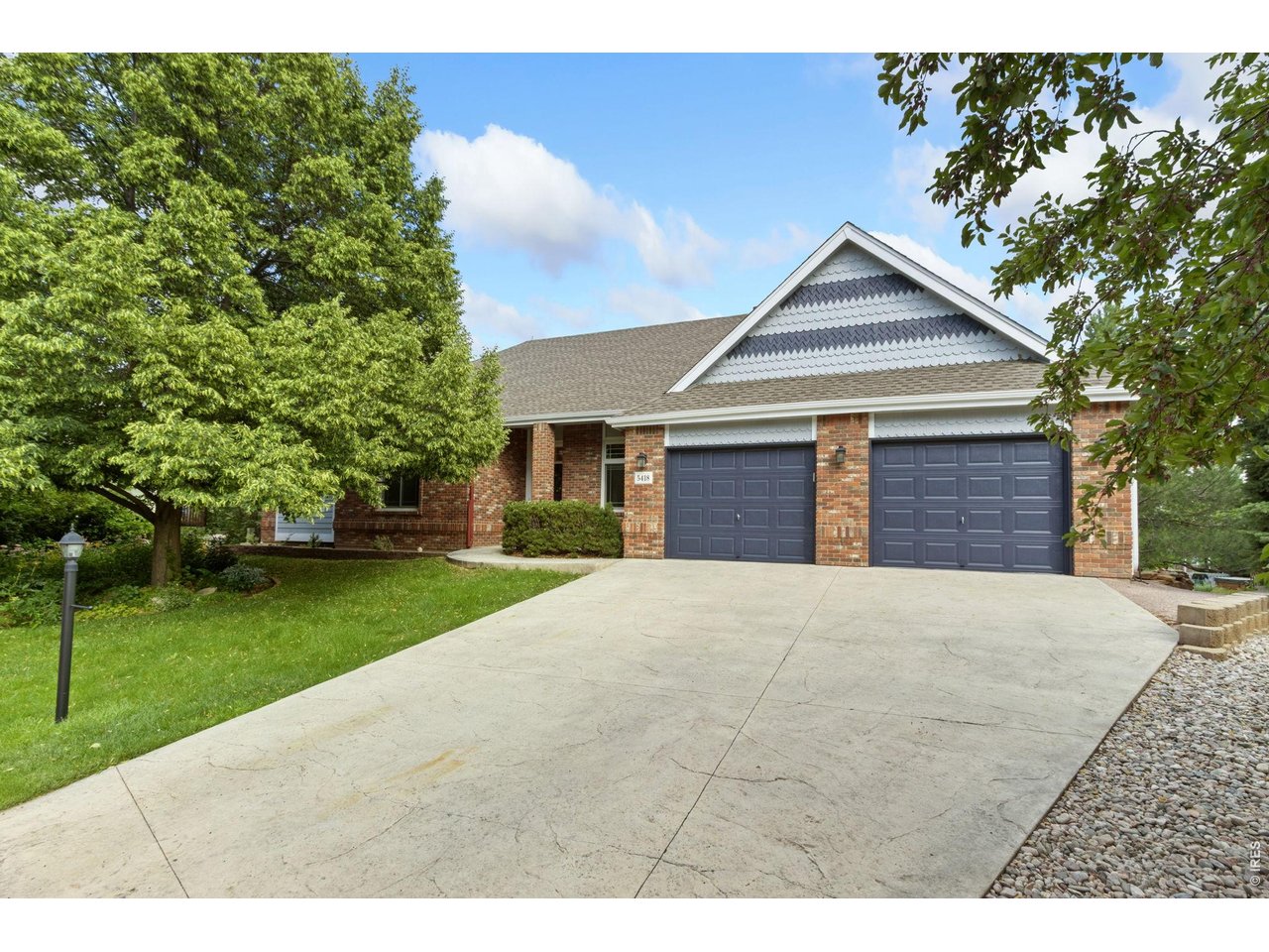 Welcome to this beautifully maintained ranch-style home tucked away on a quiet cul-de-sac in the highly sought-after Mariana Cove neighborhood of West Loveland. Brand new carpet on the main level, incredible natural light, a walkout basement, and an amazing lot make this home truly special. A recent remodel opened up the upper-level floor plan, creating a bright, airy feel throughout. The redesigned kitchen features a large center island, added cabinetry, and improved functionality-ideal for everyday living and entertaining. Enjoy close access to Boedecker Reservoir and Mariana Butte Golf Course for the perfect blend of recreation and peaceful surroundings. Set on a generously sized, beautifully landscaped lot, the home offers a traditional layout with thoughtfully separated living spaces. The main level includes a formal dining room-versatile enough to serve as a home office or extra flex space-a living room, and the updated kitchen flowing into the main living areas. The spacious primary suite features a luxurious 5-piece bath, with deck access shared from both the primary suite and the living room. Two more bedrooms, a full bath, and a half bath complete the main level. Fresh paint and refinished hardwood floors add warmth throughout. A screened-in porch opens to a wood deck overlooking the lush backyard-perfect for relaxing or entertaining. The finished walkout basement adds incredible living space: a large family room, rec room with wet bar, fourth bedroom, and 3/4 bath, opening out to a spacious backyard patio. A large three-car garage offers plenty of room for vehicles, storage, or hobbies. Set in one of Loveland's most scenic neighborhoods, 5418 Nantucket Ct is a rare opportunity for comfort, space, and an exceptional location in the heart of Mariana Cove.