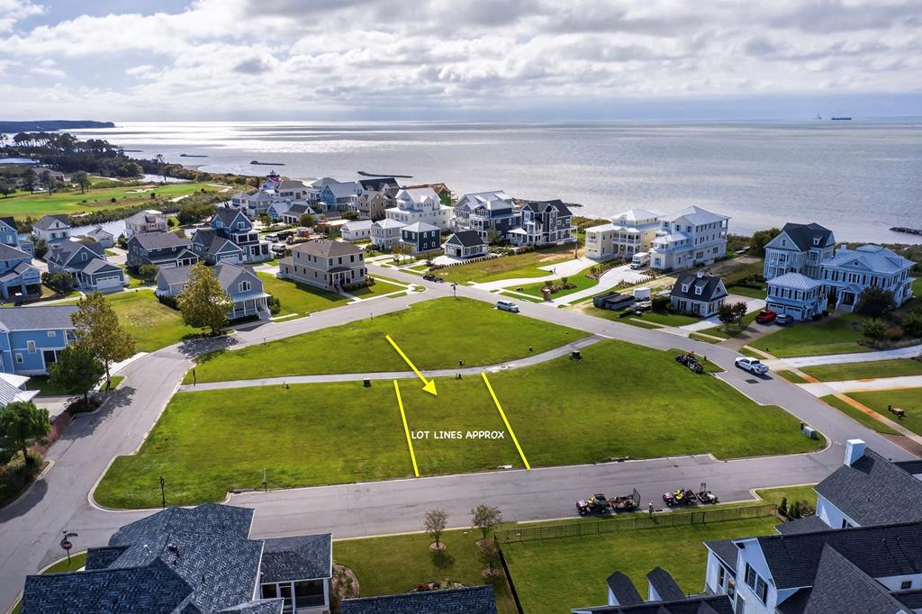 Discover an excellent opportunity to construct your ideal residence on Homesite 141 within the highly desirable Bayside Village community. Ideally positioned just moments from the bay, this homesite offers the finest aspects of coastal living, including easy access to water vistas and coastal breezes. Enjoy the convenience of proximity to the community's LifeCenter, where fitness, wellness, and social amenities. Also, 27 holes of championship golf, a two-mile private beach, six new pickleball courts, and additional amenities within the community! This homesite offers an ideal setting for a custom-designed residence tailored to your vision. The seller has thoughtfully designed home plans for prospective buyers to consider.