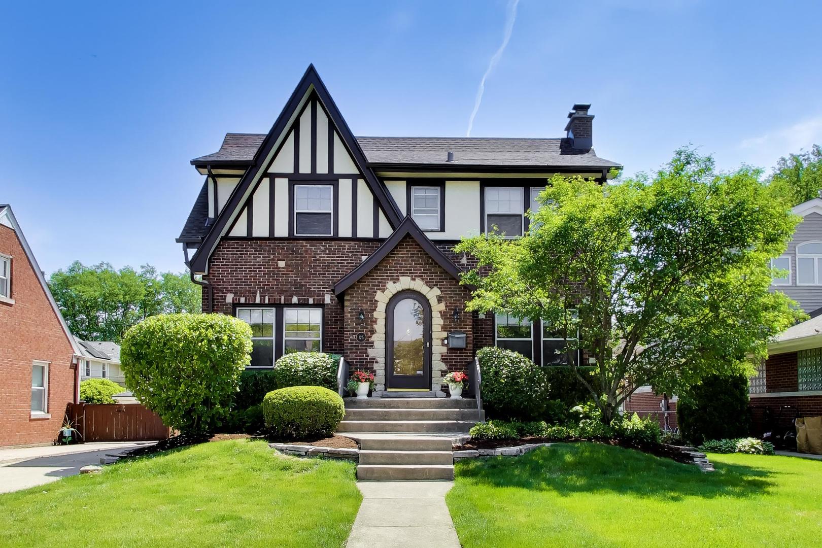 Here's a real storybook charmer, full of custom features and thoughtful updates.  A new roof, newer garage, and lush landscaping adorn the outside of this all-brick Tudor, while grand moldings, newly stained hardwood floors, a wood-burning fireplace and fresh paint make the interior shine. The current owners beautifully renovated and expanded the eat-in kitchen, to include a center island, custom cabinets and high-end appliances.  The finished basement with a second full bath lends additional living space, while the fenced backyard features an inviting paver patio and spacious lawn.  To top things off...a convenient, west-end La Grange location, close to Gilbert Park, the Metra, downtown LaGrange, and major expressways.  This is one to see!