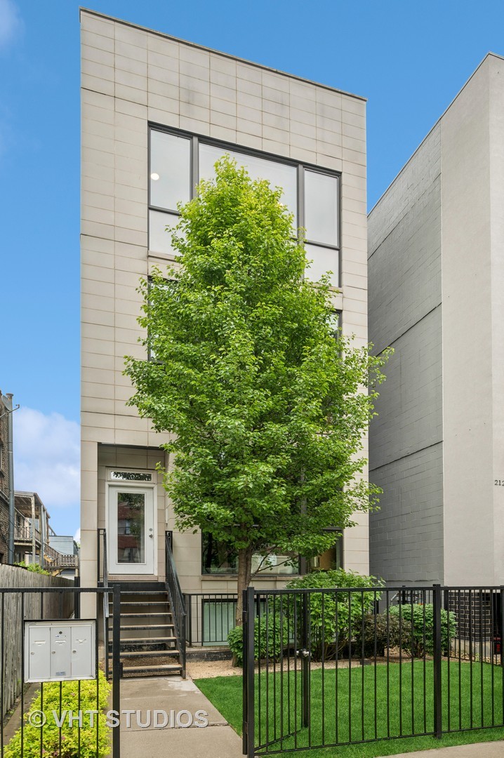 Move right into this impeccably designed, light-filled penthouse featuring an extraordinary private roof deck built-out to meet your entertaining and everyday outdoor living needs -- all in the heart of Logan Square. This gorgeous penthouse residence has been thoughtfully curated to offer elevated city living with modern style and exceptional craftmanship. Tall ceilings and floor-to-ceiling windows flood the expansive great room with natural light. The chef's kitchen is outfitted with stainless steel Bosch appliances, a Zephyr vented hood, custom cabinetry, quartz countertops with a waterfall edge, and a striking custom tile backsplash. The spacious primary suite is a tranquil retreat with a walk-in closet and in-ceiling speaker wiring, and attached bathroom. The spa-caliber ensuite bath boasts a steam shower, dual vanities, heated tile floors, and integrated audio for a true luxury experience. A well-appointed guest bedroom also features custom Elfa storage, while the guest bath includes a deep soaking tub with a seamless glass enclosure. The outdoor space is unmatched: enjoy two private areas including a rear deck and a show-stopping private roof deck designed for entertaining or peaceful solitude. Outfitted with built-in cedar seating, a custom outdoor kitchen (Weber gas grill, granite countertops, stainless steel ice chest, and sink), a steel pergola with cedar privacy panels, and built-in Definitive Technology speakers, this space is truly one of a kind. Additional features include designer lighting and Hunter Douglas remote roller shades. Garage parking and extra storage closet included. This turn-key home has been impeccably maintained and improved -- combining upscale finishes and rare outdoor space. Ideally located in Logan Square just two blocks from the California Blue Line, this home offers unbeatable access to the best of city living. Step outside to enjoy vibrant dining, eclectic shopping, and dynamic entertainment along Armitage, Milwaukee, and the historic boulevards. Easy walk to farmers market, parks and the 606!