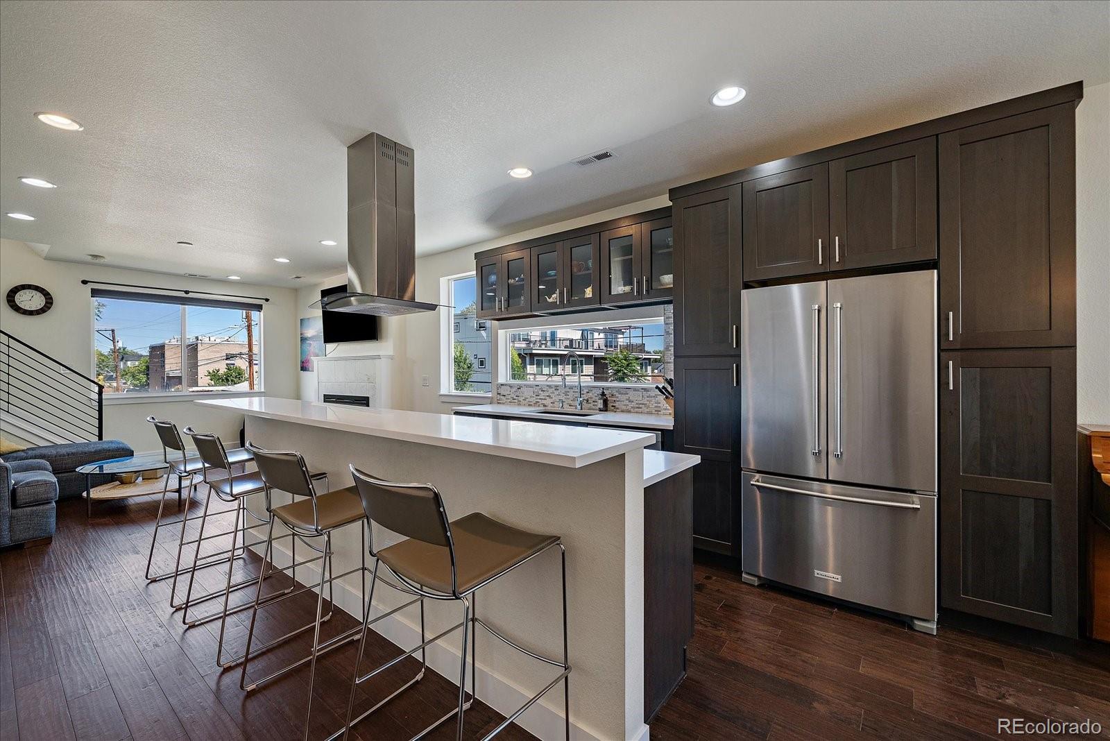 Welcome to your perfect Denver townhome retreat! This spacious 3-bedroom, 3.5-bath end unit offers the best of both comfort and convenience. Located on the quiet side of the community, furthest from Sheridan Blvd, you’ll enjoy peace and privacy with no road noise—a rare find in this prime location.
Inside, you’ll find classic, timeless finishes including Corian counters, a large walk-in pantry (hard to find in these townhomes), and a gas fireplace that sets the mood on cozy winter nights. The open main level flows easily for entertaining, while the two-car attached garage offers everyday convenience.
Upstairs, the primary suite is a true retreat with a lovely 4-piece en suite bath, while two additional bedrooms (each with their own bath access- both on separate floors) add flexibility for guests, a home office, or hobbies. From select spaces, you’ll enjoy both city and mountain views, bringing the best of Denver right to your windows.
To top it off, the rooftop deck is rated for a hot tub, giving you the perfect space to relax, unwind, and take in Colorado sunsets AND sunrises.
Enjoy the lifestyle you’ve been looking for—just minutes from Sloan’s Lake, Highland, and Berkeley for dining, shopping, and outdoor fun. Whether it’s catching sunsets, hosting friends in your stylish kitchen, or relaxing by the fire, this end unit blends lifestyle and location seamlessly.