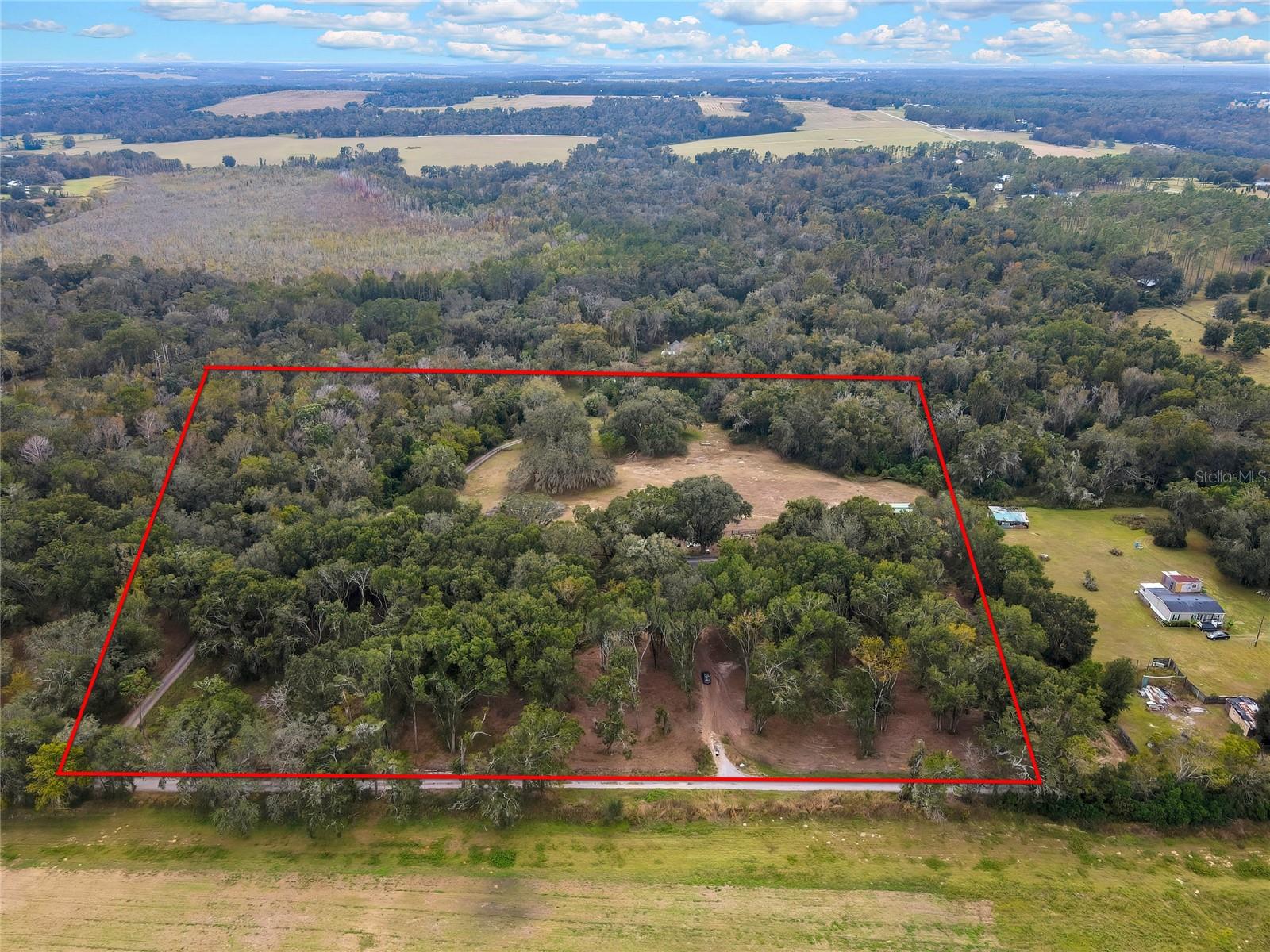 Discover the perfect blend of country living and practical functionality on this beautiful 10 acre property. Surrounded by open skies and natural beauty. This property offers endless potential for farming and creating your own private homestead. The property also includes a spacious double wide manufactured home. Offering a light and bright interior. Large living space with amble room to spread out! Call today to view as this property is priced to sell!