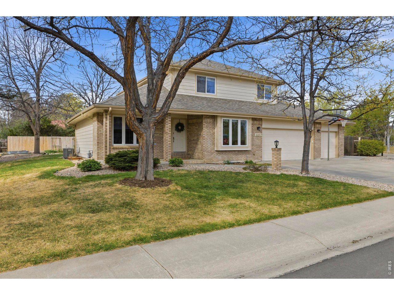 Welcome to this bright and spacious home offering a thoughtfully designed floorplan with exceptional indoor and outdoor living. A covered front patio welcomes you inside, where you'll find a front living/sitting area, a separate formal dining room, and a private main-level office with French doors. The updated kitchen features Tharp soft-close cabinets, quartz countertops, and stainless steel appliances. It opens to the inviting family room, which has a brick-surround gas fireplace, classic mantle, and built-in cabinetry. The spacious primary suite features beautiful bay windows and an updated en-suite bathroom with quartz countertops and heated tile flooring for added comfort. Basement is finished with a spacious rec room, fourth bedroom, 3/4 bathroom plus laundry area and features a separate private entrance from the garage. Outside, enjoy the covered back patio and oversized concrete deck overlooking a large backyard with mature landscaping and a storage shed. Car enthusiasts, hobbyists, or anyone needing extra space will appreciate the rare finished 4-car garage, large attached shop with multiple 220v outlets and backyard access, and RV-capable side parking, offering incredible flexibility and storage options. Located near Johnson Elementary and across from Webber Middle School and on a corner lot, this home combines comfort, functionality, and standout features that are hard to find in one property. It has been meticulously maintained and is move-in ready for its next owner!