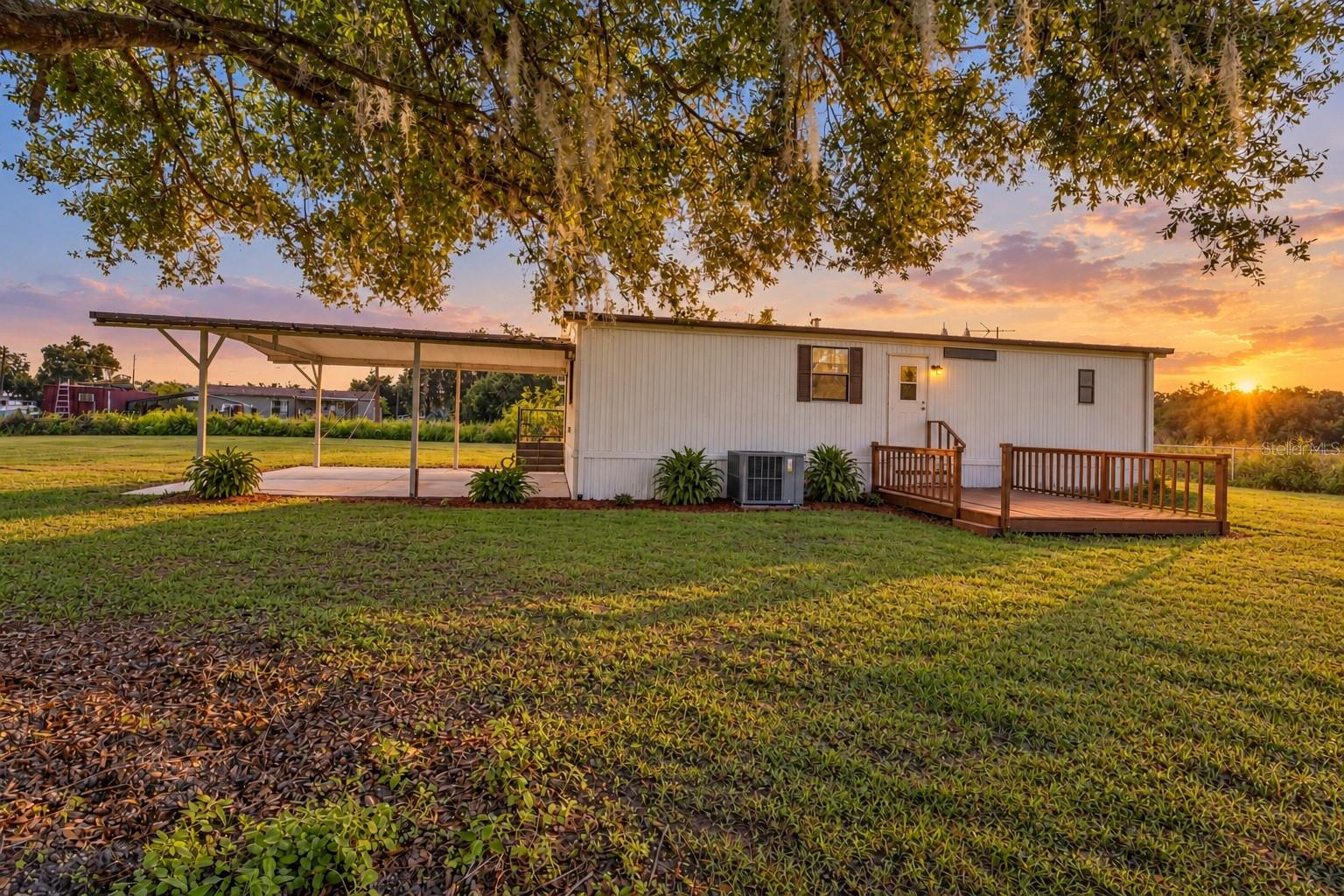 Enjoy the peace and privacy of country living with NO HOA, NO CDD, and 1.39 ACRES to call your own! Tucked away in a quiet Plant City setting, this manufactured home offers the perfect opportunity to enjoy wide-open spaces, peaceful surroundings, and the freedom of rural living without sacrificing everyday convenience. Mature trees provide beautiful natural shade, while the expansive yard offers plenty of room for gardening, outdoor activities, or simply enjoying the tranquility of your own private retreat.Inside, you'll find a comfortable living area, a dedicated dining space, and a functional kitchen featuring wood cabinetry and a convenient breakfast counter. A separate laundry room adds to the home's practicality.Step outside and take advantage of the spacious covered carport, offering sheltered parking and additional flexibility for outdoor use. An outdoor deck provides another inviting place to relax and enjoy the fresh air, while a detached storage building offers space for tools, lawn equipment, and other essentials.Location adds to the appeal! Enjoy the quiet atmosphere of country living while remaining conveniently close to supermarkets, shopping, dining, and Interstate 4, providing easy access to Tampa, Lakeland, and surrounding areas.With 1.39 acres, NO HOA, NO CDD, and a peaceful setting, this property offers a rare combination of space, privacy, and convenience. Whether you're looking to escape the hustle and bustle, enjoy more time outdoors, or simply have room to spread out, 3807 Rooster Lane is ready to welcome you home. Schedule your private showing today