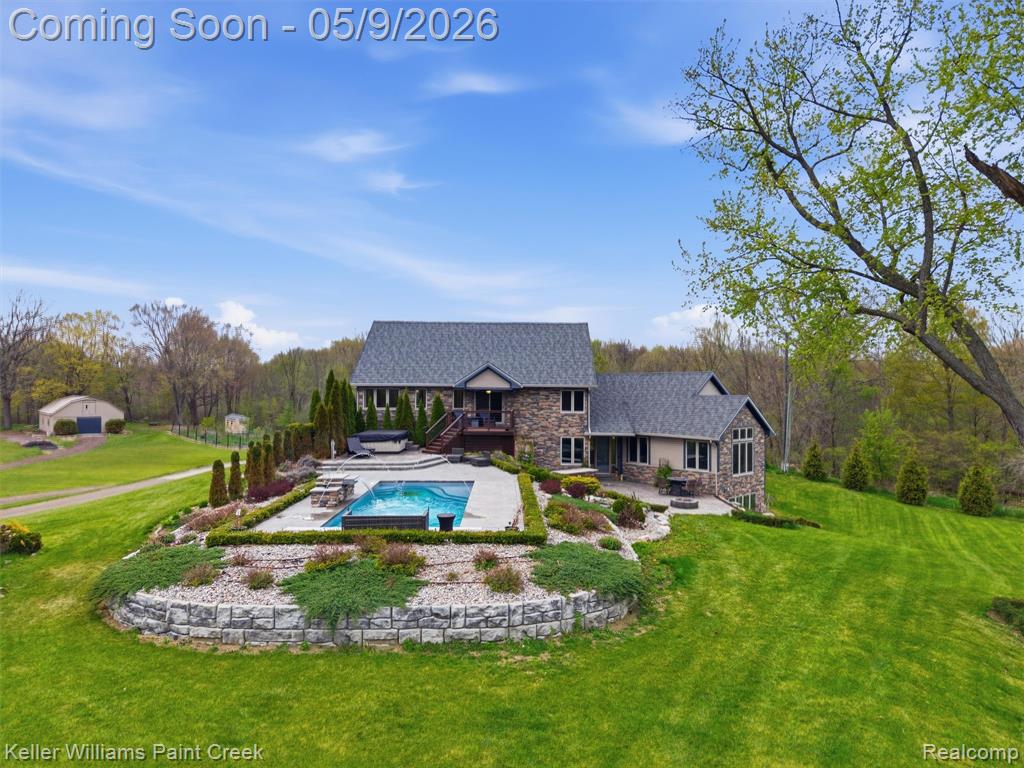 A rare opportunity featuring 2 separate residences on 10 private acres! Welcome to your own private retreat of scenic land designed for relaxation, recreation, and everyday living. Mature, professional landscaping, and gardens, this one-of-a-kind property features 3 aerated spring-fed ponds, including one with a sandy beach and swim area, complete with a pergola and firepit.The main house- 3 bed/ 4 full baths and a finished walkout basement featuring a 4th bedroom, full bath, and prep for a second kitchen. A 1,000 sq ft Primary suite includes a private ensuite bath, oversized closet, sauna and access to a private deck. Upper-level laundry. Gourmet kitchen was fully remodeled in 2025.Pantry, breakfast area and living room with vaulted ceilings with surrounding windows. Pet Washing Station, and Mudroom with storage bench. Outdoor living features an inground saltwater pool (2021) with power cover, an 8-person saltwater hot tub, outdoor hibachi-style grill, Ivy wall water feature, and exterior lighting throughout.  Huge pole barn equipped with electric and water provides excellent space for storage, stables, or workshop use, along with additional sheds and dedicated garden space. New septic (2021), and a 100-year metal roof (2021)The 2nd home dwelling- This guest home features 1,091 sq ft with 2 bedrooms, 1 full bath, kitchen, living room, laundry room, and a heated garage with a high-rise door. Perfect for extended living, guests, or potential rental / business use. Home was remodeled in 2023- includes updated roof and siding. Full irrigation system. With a rare combination of acreage, water features, and multiple living spaces, this exceptional property offers privacy, versatility, and a truly distinctive lifestyle opportunity.