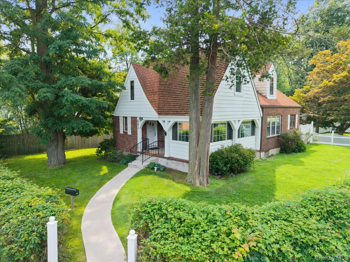 Nestled in the desirable Poet’s Corner neighborhood and set well back from the street, this charming brick Tudor offers 4 bedrooms and 2 full baths on a beautiful .28-acre property with a private, fenced backyard. Filled with character, the home features hardwood floors, original architectural details, a stone fireplace, arched openings, and abundant natural light. The spacious living room with fireplace opens through French doors to an inviting enclosed sunroom, while the gracious formal dining room provides plenty of space for gatherings and entertaining.  A versatile floor plan includes two bedrooms on the first floor and two bedrooms upstairs, offering flexibility for guests, a home office, or those who prefer first-floor bedroom options. Upstairs, the spacious primary bedroom features exposed wood beams, and a wood-burning fireplace, adding to the home’s distinctive character.  The outdoor space is a true highlight. The large, private backyard, surrounded by mature trees and fencing, offers plenty of room for gardening, play, and outdoor entertaining. A deck with an awning overlooking the backyard provides a wonderful spot to relax and enjoy the peaceful setting.  Enjoy all that the Town of Greenburgh has to offer, with convenient access to Town parks, recreation programs, and facilities. Anthony F. Veteran Park offers swimming pools, tennis courts, basketball, playgrounds, and picnic facilities, while Greenburgh’s extensive recreation programs provide activities for a wide range of ages and interests. Convenient to Bee line Route 38 commuter bus with a stop just steps away, providing direct service to Hartsdale Metro-North station.  With approximately 2,240 square feet, a versatile bedroom layout, classic brick Tudor character, generous outdoor space, and convenient access to Greenburgh’s parks and recreation, this home offers a wonderful combination of space, privacy, character, and potential!
