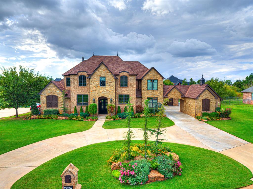 Welcome to Summit Lake Estates, one of Edmond’s premier gated communities featuring private stocked lakes, scenic walking trails, and a lifestyle of luxury and privacy. This grand estate is sure to impress with its PORTE COCHERE ENTRY, CIRCLE DRIVE, and timeless architectural details. Inside, you’ll find authentic hand-scraped HARDWOOD FLOORS and 6-inch crown molding flowing seamlessly throughout the home. The living room is a true centerpiece with its floor-to-ceiling stone fireplace, rustic wood beams, custom built-ins, and abundant natural light. The gourmet kitchen is designed for the serious chef, boasting professional-grade appliances by Thermador, Bosch, and KitchenAid, accented with reclaimed wood touches and a classic Kohler farm sink. An oversized walk-in pantry provides ample storage with both cabinetry and countertop workspace.
Working from home is effortless with an executive study featuring custom built-in bookcases, a separate home office, and a convenient drop-zone mudbench. For entertaining, the game room showcases a charming brick accent wall, snack bar, & built-in entertainment center. Retreat to the primary suite with 12ft ceilings, spa-like bath featuring a freestanding soaking tub and walk-in shower, and large closet with built-ins. Upstairs, you’ll find four spacious bedrooms, an exercise room, and an oversized walk-in closet designed to accommodate large storage items—perfect for keeping your Christmas tree fully assembled. There is even a secret room upstairs hidden behind a book case - shhhh! Outdoor living is equally impressive. The 520sf covered patio features remote-controlled PHANTOM SCREENS, brick arch privacy walls, and a cozy outdoor fireplace. The home’s setting is truly unique, offering a PRIVATE STOCKED POND shared with just one neighbor. With generous storage throughout, elegant finishes, and thoughtfully designed spaces for work, play, and relaxation, this home HAS IT ALL! Ask for the FULL FEATURE LIST and come see today!