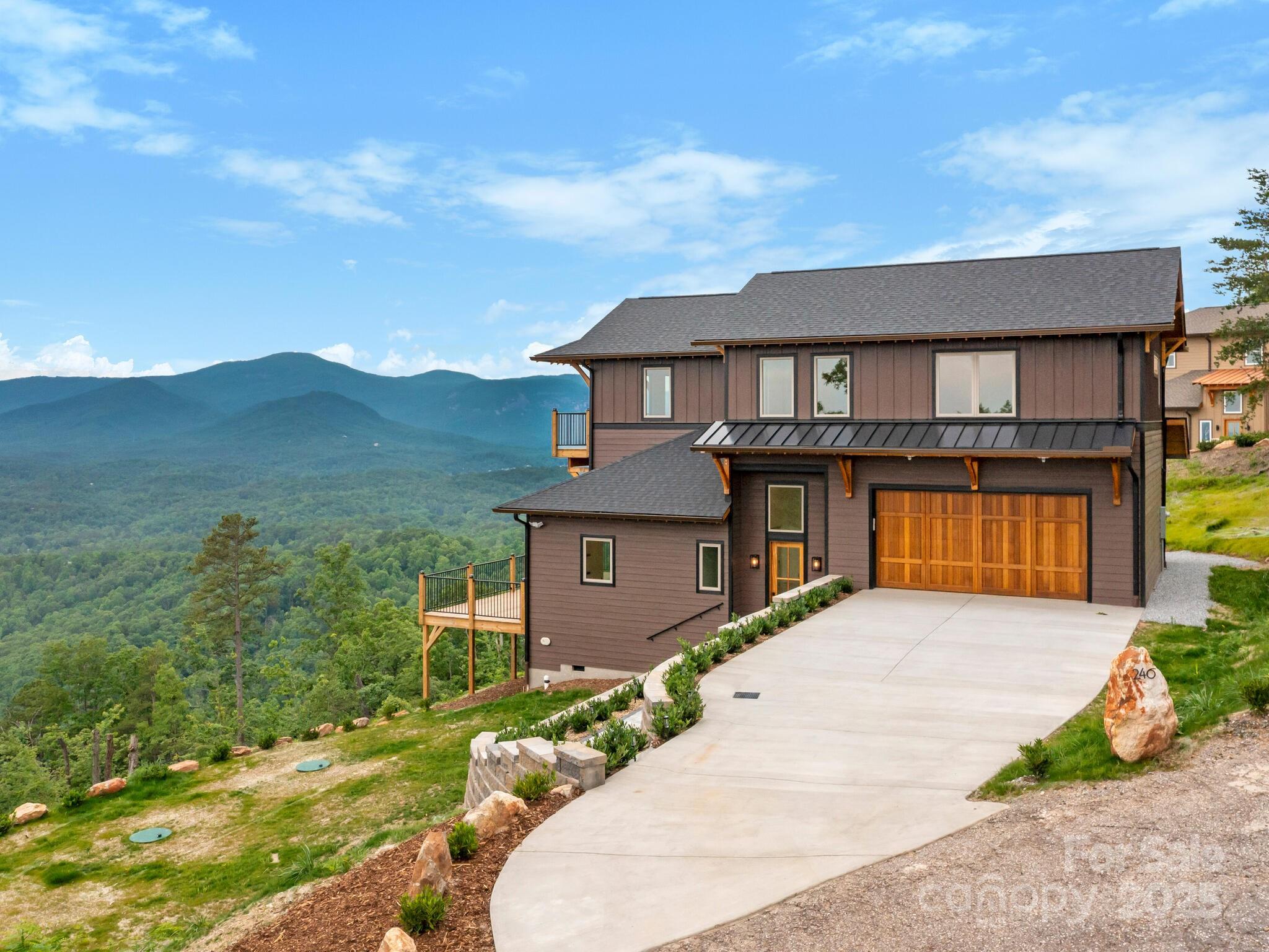 Amazing new construction 3 bedroom, 3.5 Bath + Office + Loft home just finished by top-notch builder in the exclusive, gated community of Vista at Bill's Mountain, Lake Lure. Offering the perfect blend of modern luxury and natural beauty, this single-family home boasts 3 spacious bedrooms with Owner's Suite on the main level, 3.5 baths, and a design that maximizes breathtaking sunset mountain views of Hickory Nut Gorge & Chimney Rock, plus views of Bald Mountain, Rumbling Bald Mountain, Tryon Mountain, and Sugarloaf Mountain. Whether you're enjoying a relaxing evening out on the huge deck or at the fireplace, you'll be surrounded by the beauty of long range, multi layered views of the mountains.  
Vista at Bill's Mountain is an upscale gated community featuring a grand clubhouse, fitness room and dressing rooms with saunas, outdoor pool, tennis courts, and walking trail.  Only 45 minutes to Asheville Airport, 60 minutes to Greenville Spartanburg GSP, and 90 minutes from Charlotte CLT.