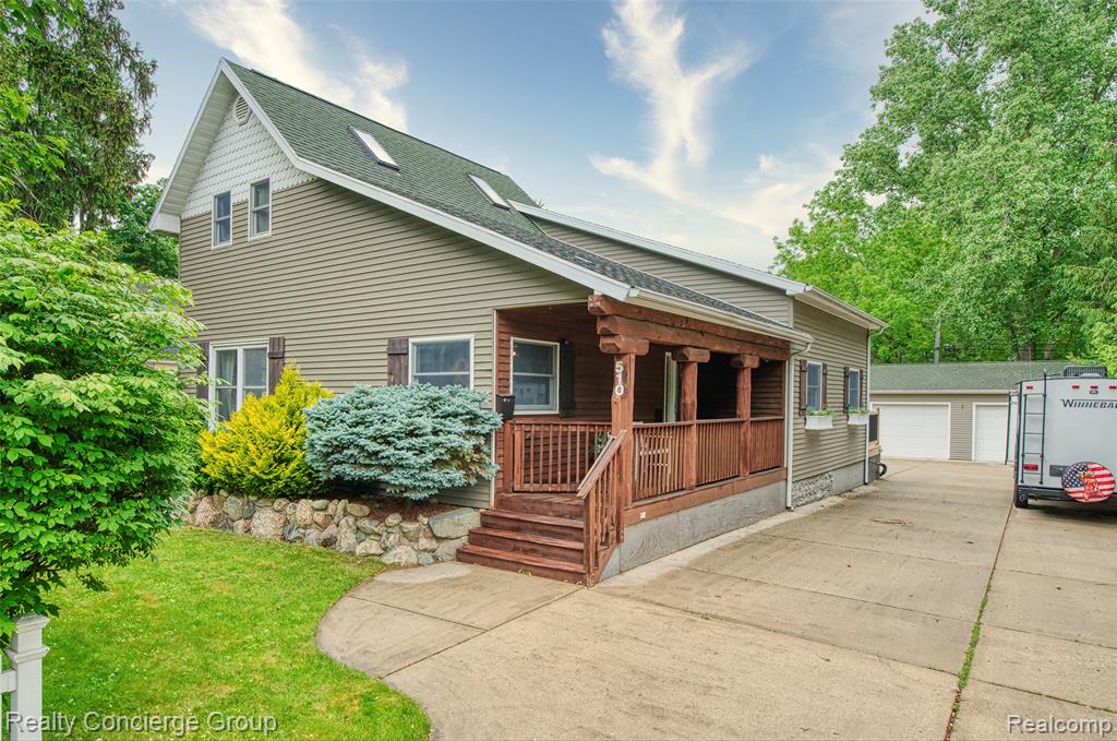 Welcome to this adorable, updated bungalow offering 2 bedrooms, 2 full baths, and 1,535 sqft of charming living space nestled on a spacious lot in the heart of Mason. From the moment you arrive, the covered front porch invites you to sit back and relax, while the oversized 2.5-car detached garage provides ample space for vehicles, tools, or hobbies. Inside, the open-concept main level features a bright and welcoming living room that flows seamlessly over to the kitchen — ideal for entertaining or everyday comfort. The kitchen boasts counter-height seating or table dining, abundant counter and cabinet space. The main floor also boasts a bonus bar area, perfect for hosting family and friends. The main-floor primary bedroom offers a generous closet and a beautifully appointed ensuite bath complete with a soaking tub for ultimate relaxation. An additional full bath on the main level and a spacious upstairs bedroom with a bonus office nook create the perfect setup for guests, kids, or working from home. Outside, enjoy the freedom of no HOA, a large backyard, storage shed, and an oversized deck overlooking the property — ideal for summer BBQs or quiet evenings. Whether you're looking to park your RV or bring your toys, this property is the perfect fit. Conveniently located near all the amenities Mason has to offer, this home blends comfort, functionality, and flexibility — all in one adorable package.