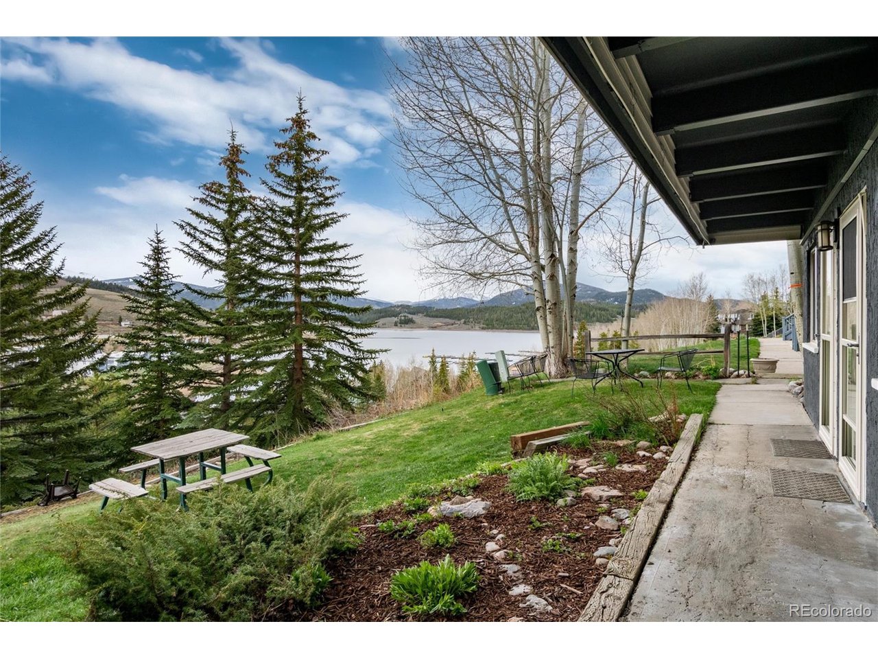 This quiet, private ground-floor unit sits well away from the parking lot and faces the lake, offering a peaceful retreat in the heart of Dillon. Completely turn-key and beautifully remodeled, the space feels bright, modern, and welcoming. The traditional galley kitchen has been transformed into an open layout with a rare walk-in pantry you won't find in any other unit. Private in-unit laundry-another uncommon upgrade-adds everyday convenience. Rather than a small balcony, enjoy direct access to a wide lawn with barbecue space, flowerbeds, and stunning lake, marina and mountain views. With the bus route steps away and Dillon's restaurants, amphitheater, farmers market, bike paths, pickleball courts, and paddle sports all within walking distance, this home delivers true four-season living: lake life all summer, access to premier snow sports all winter.