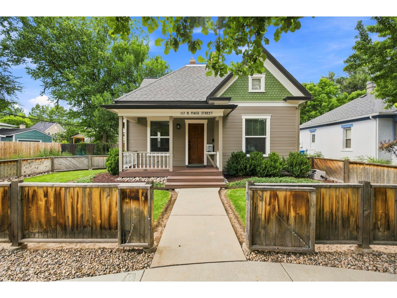 Storybook charm awaits in one of Fort Collins' most treasured neighborhoods. Nestled on peaceful Mack Street, the covered front porch invites you to slow down & take in this special place. The leaves in the trees dance, neighbors stroll by, the trolley & Mountain Avenue's wide sidewalks are in sight. Hickory wood floors, dormers, built-ins, and classic details celebrate the home's historic character. Originally built in 1898, this delightful 1 1/2 story home was reimagined in 2010 with extensive renovations, new windows, and major system updates. The sun-soaked living & dining rooms open to the kitchen which features white shaker cabinetry, beautiful Caesar stone countertops, and a gas range. With five bedrooms and three full bathrooms, including the main floor primary suite, this flexible floor plan offers room to grow & room to gather. Upstairs loft brings even more living options: movie nights, play room, or craft space. The park-like backyard, with stamped concrete patio & large composite deck, creates the ideal setting for al fresco dining, morning coffee, and memorable evenings with family & friends. This sweet home, located blocks from the best of Fort Collins- dining, shopping, City Park, Dunn Elementary, Poudre River Trail, and Colorado State University, has alley access on two sides. It's unmistakably Old Town, where coming home just might be the best part of your day.