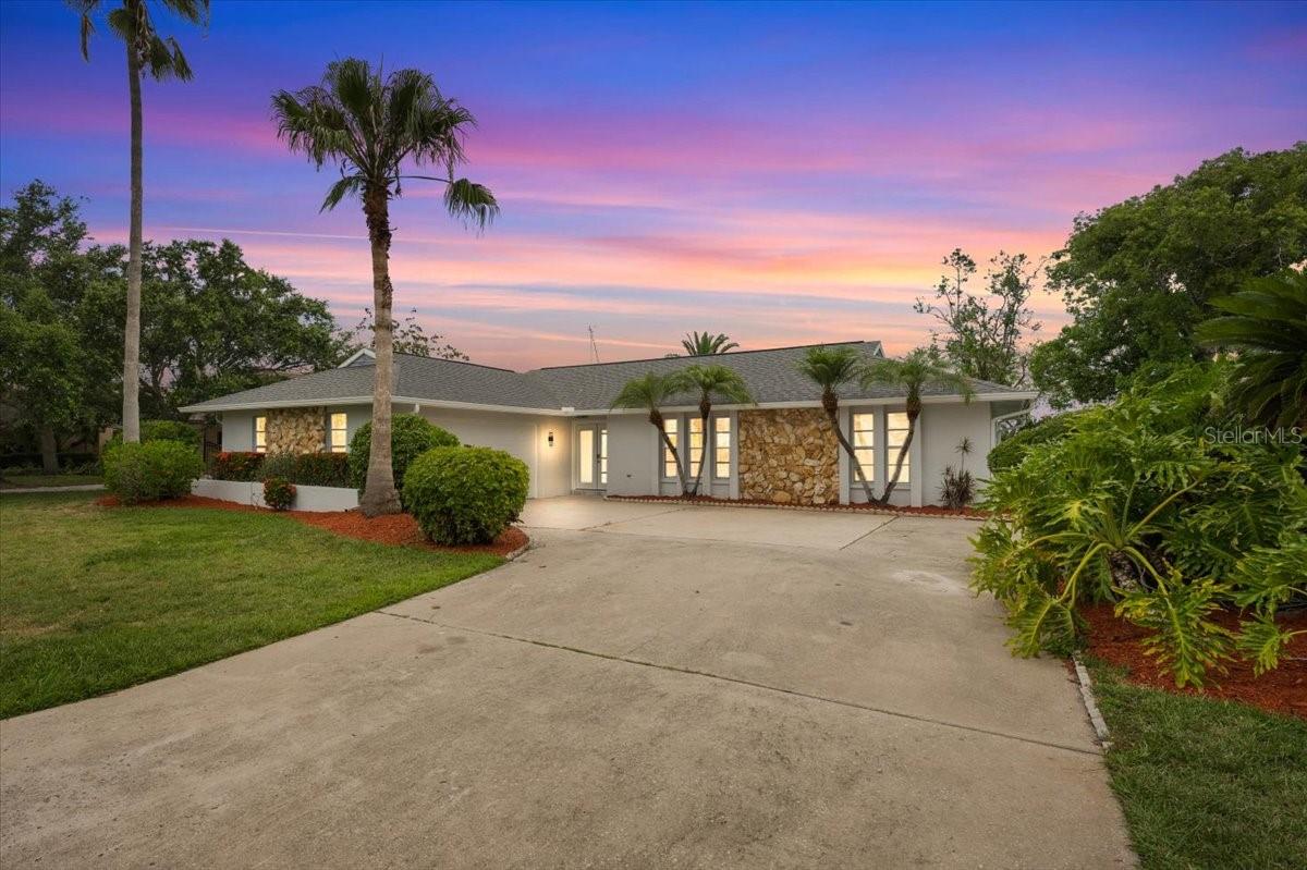 Imagine waking up every day to peaceful canal views, with 90 feet of waterfront, right from your own piece of Florida paradise with no rer neighbors. Located in the highly sought-after Gulf Harbors Woodlands, this 3-bedroom, 2-bathroom waterfront home features wood look plank tile throughout the home and a bright, open-concept floor plan designed for comfortable living and entertaining. The kitchen includes a huge central island that is perfect for meal prep, eat in dining, and gathering. As you enter the living room, you are invited by tall vaulted ceilings, an electric fireplace with decorative shelving on the sides, and an exceptionally long 6-panel accordion glass door that opens to the backyard.Step outside onto the screened-in back porch, which also features tall vaulted ceilings, creating the perfect open space for you and your guests to sit and enjoy views of canal with direct deep water gulf access in minutes.. The outdoor area also includes a screened-in ground pool, and a private dock. The master bedroom includes a walk-in closet and an en suite bathroom with dual sinks, LED mirrors, and a tiled stand-up shower. The second bathroom also includes a dual-sink vanity and LED mirrors. The Gulf Harbors Woodlands community includes access to the clubhouse, community pool, and tennis courts and it offers you the option to join the private Gulf Harbors Beach for just $200 a year. Gulf Harbor Woodlands is a golf cart friendly community with easy access to downtown New Port Richey, and tons of restaurants shops and stores. Schedule your tour today!