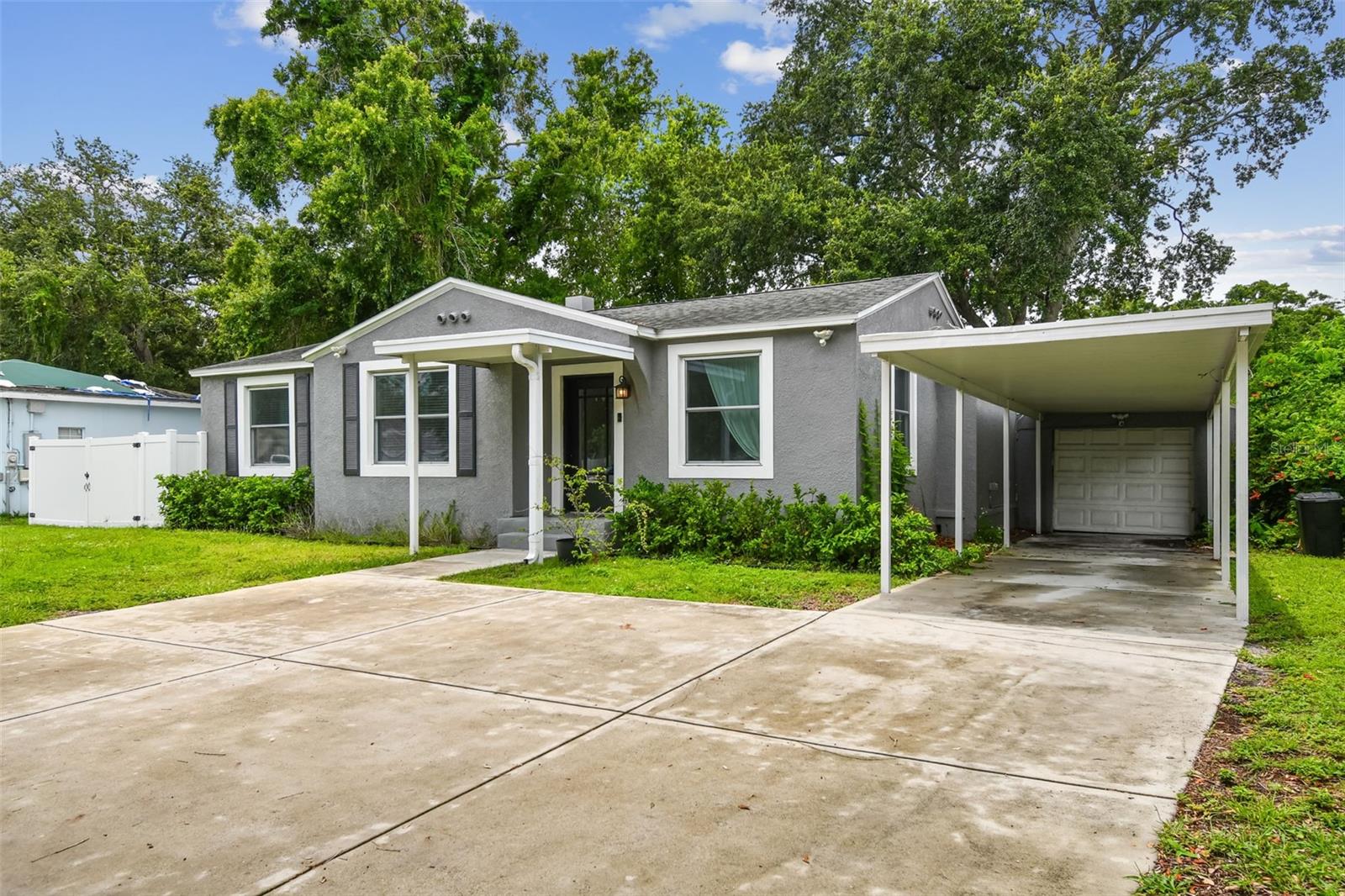 MAJOR PRICE IMPROVEMENT!  Charming South Tampa Home in the Plant School District- UNTOUCHED BY RECENT STORMS! ALSO AVAILABLE FOR LEASE (TB8397538). Located just a stone’s throw from everything South Tampa has to offer, this beautifully remodeled 3-bedroom, 2-bath concrete block home offers 1,726 square feet of stylish and functional living space. Elevated on a crawlspace, the home boasts peace of mind with newer systems, including the roof, windows, and HVAC. Step inside to find seamless throughout and an open, airy layout filled with natural light. The fully updated kitchen features quartz countertops, modern finishes, and a cozy nook—perfect for a coffee bar or work-from-home setup. At the rear of the home, a stunning Florida room with wall-to-wall windows invites the outdoors in, creating a sun-soaked space for relaxing or entertaining. The home also includes a versatile flex space, ideal for an office, playroom, or craft area. Additional highlights include a spacious built-in pantry, an attached one-car garage with an additional carport featuring a hot water spigot, and a fully fenced oversized backyard with endless potential for outdoor living. Don’t miss this opportunity to live in a move-in-ready home in one of Tampa’s most sought-after neighborhoods!