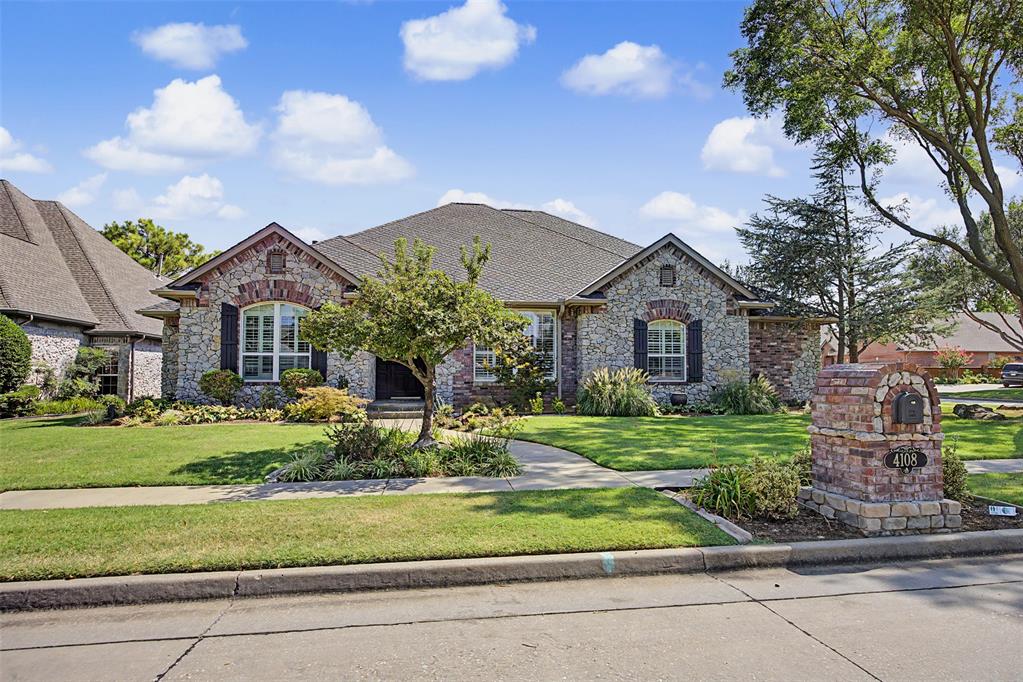 Welcome to Brookhaven in west Norman,  you will love it here! This spacious 5-bedroom 3-bath home is just the place you are looking for to spread out and put down roots. The curb appeal is everything, with tasteful landscaping and the striking rock and brick construction. Being situated on a corner lot, you really get to enjoy an expansive view of the home. Step inside the front entry and turn to the right, you will find that the formal dining area provides a welcoming first impression and offers flexibility for more than traditional dining. This versatile space could also make a wonderful library nook, music room, or reading area. Opposite from there you will find the study with a double door entry and charming transom light. This home office includes a closet, so it could optionally function as a true 5th bedroom, guest room, nursery or additional living space. Straight ahead, the home opens into a spacious living room centered around a grand fireplace and two large flanking windows. You will love the cathedral ceilings and classic moldings that give this space a sense of sophistication. From there, the living room flows naturally into the homey eat-in kitchen. Enjoy tons of natural light, ample counter and cabinet space, functional prep island, gas range, double ovens, and butler’s pantry. What a dream space for whipping up a cozy dinner or tackling larger-scale entertaining! Either way, it’s a true heart of the home. The primary suite provides another distinctive feature with a two-sided brick fireplace shared between the bedroom and bathroom, adding warmth and ambiance to both spaces. Enjoy separate vanities, a huge soaking tub, a gorgeous tiled shower, and tons of closet space full of custom built-ins for ultimate organization. Access to the gorgeous back patio from the primary suite is another wonderful touch. Three additional bedrooms offer a ton of flexibility, one even features coffered ceilings and a separate entry.