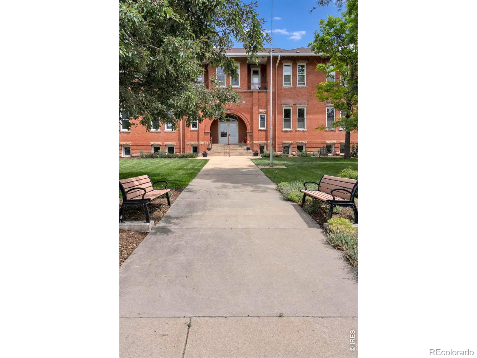 Rare opportunity to own a stunning top-floor condominium in the historic Washington Village Schoolhouse, Located within a secure elevator building with only eight residences, one of North Boulder's most distinctive residential communities. Offering the ease of one-level living, this spacious 3-bedroom, 2-bathroom home combines historic charm with modern comfort in a beautifully renovated building completed between 2013 and 2015. Filled with natural light, the open-concept floor plan features soaring ceilings, mountain views, and custom finishes throughout. The seamless flow between the kitchen, dining, and living areas creates an inviting atmosphere for both everyday living and entertaining. Just off the living room, a private outdoor deck provides the perfect space to relax. The modern kitchen offers abundant granite countertop space, storage, and ample seating. The spacious primary suite features a large walk-in closet and a beautifully appointed en-suite bathroom. There is an in-unit laundry room, while a bonus storage room is located just outside the unit. An oversized private garage provides additional storage. Residents enjoy beautifully maintained gardens and private park spaces, along with an impressive collection of amenities rarely found in condominium living - these include an art studio and workshop, library, communal kitchen and meeting space, yoga and fitness room, fireside lounge, overnight guest suites, meditation spaces - all to foster community and connection.The location is truly exceptional - just steps from North Boulder Park, Ideal Market, local restaurants and cafes, boutique shopping, the North Boulder Rec Center, and some of Boulder's most beloved open space trails. Enjoy the perfect balance of peaceful neighborhood living with easy access to downtown Boulder and everything the city has to offer. Heating is included in the HOA dues, adding even more value and convenience to this extraordinary North Boulder home.