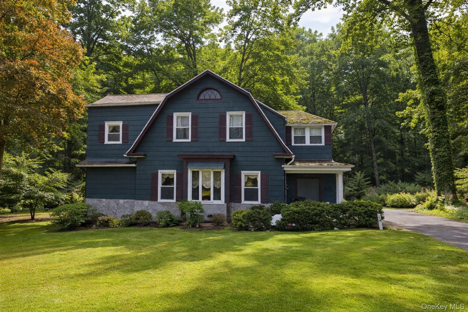 Picture-perfect Dutch Colonial with good bones, a great layout, and beautifully LOW TAXES!  Enjoy tranquil wooded views, yet have easy access to highways, parkways and transit and hike or bike to the Purchase Community House.  After many years in the care of the same owner, it is ready for its next chapter.  The home has amazing potential and just needs a little TLC to handle deferred maintenance.Touring the home ...Enter through the spacious multi-purpose screened porch and into a functional foyer with two generous entry closets. The large living room features a wood-burning fireplace and flows into the formal dining room, which leads to the open kitchen with a breakfast nook and a door to the deck and flat backyard.The kitchen opens to the family room with a cozy wood stove, creating an inviting space for daily living and gathering. A first-floor bedroom- ideal for a home office or guest room- along with a full bathroom and laundry room complete this level.Upstairs, the primary suite includes a large en-suite bath with soaking tub, walk-in closet, and a spacious alcove that can serve as a dressing area, sitting room, or office nook. With two additional closets and a balcony, the suite offers a comfortable private retreat. Three additional bedrooms and a full hall bath complete the second floor.The lower level provides abundant storage and walk-out access to the yard.Located in a community known for having some of the lowest property taxes in Westchester County and served by an acclaimed school district- one of the few in the county to offer the International Baccalaureate (IB) Program- this home offers space, flexibility, and opportunity.  Make it yours!
