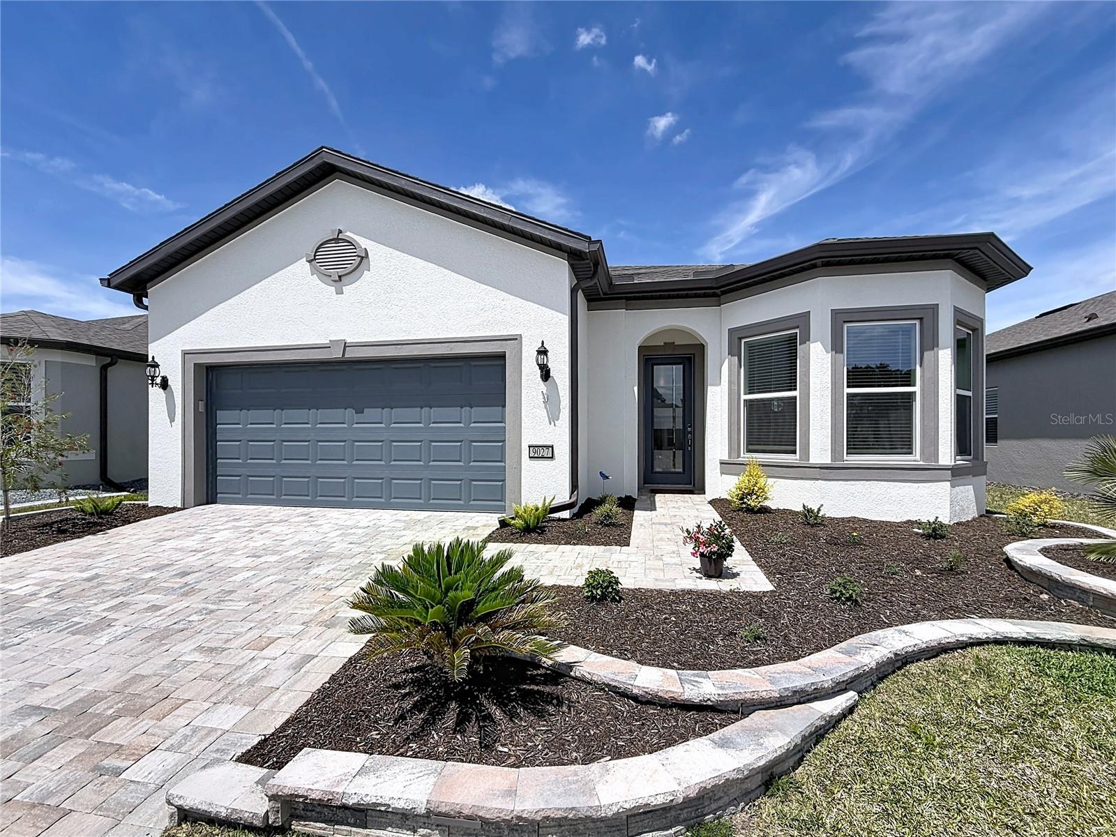 Welcome to this beautiful nearly new Mainstay model home, just over a year old, located in Stone Creek; a premier 55+ community offering resort-style living and exceptional amenities. This thoughtfully designed residence features a spacious layout with tray ceilings, quartz countertops, and a gourmet kitchen complete with a tile backsplash, soft-close cabinetry, and convenient pull-outs.The kitchen is equipped with Whirlpool appliances, including a refrigerator, electric range, dishwasher, and microwave. The home also boasts upgraded fixtures throughout, ceiling fans in every room, durable upscale Level 3 tile throughout, and a Level 5 tile kitchen backsplash. Bathrooms feature tile extended to the ceiling for a clean, modern finish.Step outside to enjoy the beautifully landscaped backyard with custom plantings and micro irrigation, along with outdoor lighting in both the front and back. Additional highlights include city water and sewer, front irrigation, and custom stonework that enhances the home’s curb appeal and overall charm.Enjoy the unmatched lifestyle Stone Creek offers, featuring two clubhouses with a full calendar of events and classes, a gated entrance, fitness center, resort-style pool and spa, pickleball and tennis courts, and dog parks. Plus, Wi-Fi and cable are included for easy living. Just outside the community gates, you’ll find a restaurant grill, and golf course, adding even more convenience and recreation right at your fingertips.