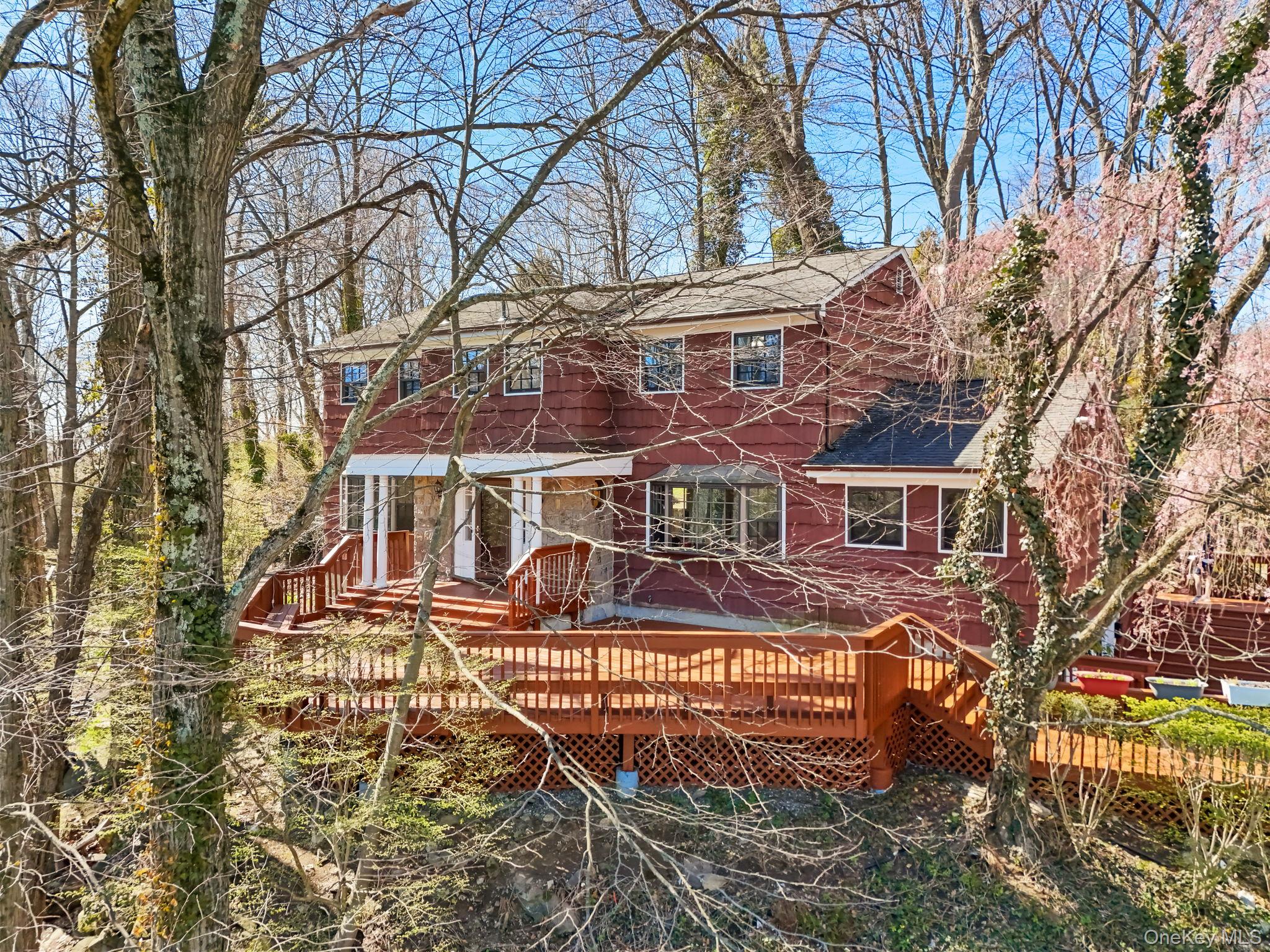 Welcome to 10 Highridge Road, a spacious and versatile 4-bedroom, 3 full and 1 half bath Colonial in the Edgemont school district offering 2,720 square feet of comfortable living space in a private, tranquil setting near downtown Hartsdale.  This home offers generous room sizes, a versatile floor-plan, and exceptional outdoor areas with elevated, bucolic views - great for everyday living and for gatherings large and small, inside and out. Outdoor living is a true highlight of the property. Two large decks in front and back provide abundant space for dining, relaxing, entertaining, and enjoying the peaceful surroundings. Whether hosting summer get-togethers, having morning coffee, or enjoying an evening outdoors, these decks extend the living space in a meaningful way. True to its address, 10 Highridge is set above many of the surrounding properties, creating a unique sense of openness, privacy, and perspective that is not often found; Nearby homes are all but completely out of site wherever you look. The elevated setting enhances the views and gives the property a special feel. Inside, the floor plan can easily adapt to a multitude of diverse needs. Whether you are looking for dedicated work-from-home space, multi-generational flexibility, room for a nanny or guests, or simply the ability to spread out, the layout offers virtually endless options. Upstairs, the generously proportioned primary bedroom provides a comfortable retreat with plenty of room to unwind. Three additional bedrooms and a hall bath complete the second level, offering ample space for guests, hobbies, or additional work-from-home needs. The above-ground lower level features a comfortable recreation room, yet another versatile space that can accommodate multiple uses. The location offers an outstanding combination of tranquility and convenience. Set on a quiet dead-end street, the property enjoys a peaceful residential feel while remaining close to everything. Edgemont Junior/Senior High School is just a short walk away; Downtown Hartsdale is 0.4 miles, with its shops, restaurants, train station and weekend farmer’s market. Downtown White Plains is only a 5-minute drive, offering additional dining, shopping and entertainment options and, of course, New York City is just over 20 miles away, allowing for convenient access while still enjoying the benefits of suburban living. The nearby Bronx River Parkway provides a quick start to any car ride south to the City while the Metro North express train can get you there in under 35 minutes. This is a home that works equally well for quiet daily living and easy entertaining, all in a location that offers both privacy and close proximity to major conveniences. A special opportunity in Edgemont and not to be missed.