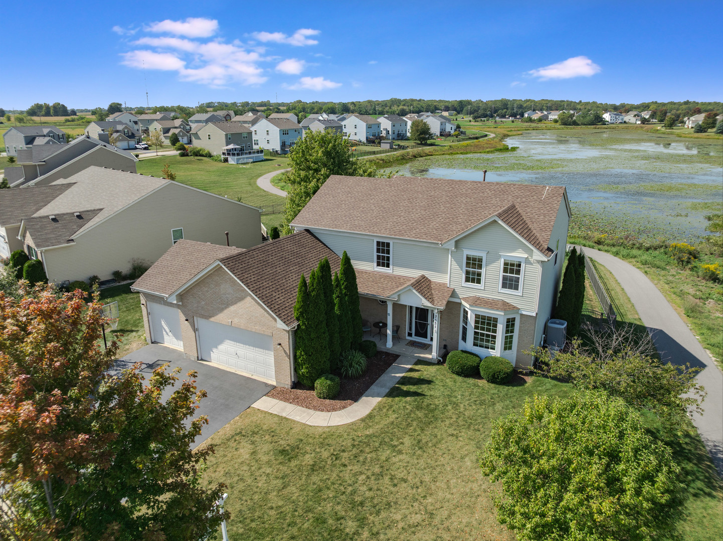 CUSTOM PRIVATE BUILD by Wiseman-Hughes ~ Builder PAID OFF the SSA making LOWEST TAXES AROUND per square foot!  This 4-5 bedroom is an ENTERTAINERS' DREAM: POND VIEWS, swimming POOL, tiered DECK, shade trees, FIREPIT, fully FENCED BACKYARD and more!  PERFECT location next to NATURE AREA and WATERVIEWS.  Only one NEIGHBOR, yet CONVENIENTLY close to park & walking path.  Inside you'll appreciate NEW CARPETING (2025), NEW Water Heater (2025), NEW STAINLESS APPLIANCES (2022): Refrigerator, Stove, Dishwasher & Microwave, custom STONE backsplash and beautiful CHERRY cabinetry.  First floor FLEX room: playroom, bedroom or office - your choice!  Master en suite with trayed ceilings, a LARGE walk-in closet and bathroom with CATHEDRAL ceilings, dual vanity and separate tub & shower.  ZONED efficient HVAC system ~ FULLY HEATED 3-car GARAGE (2015 - SECOND forced air system) ~ BRAND NEW ROOF (July 2025)!  Move-in ready to WELCOME you HOME!
