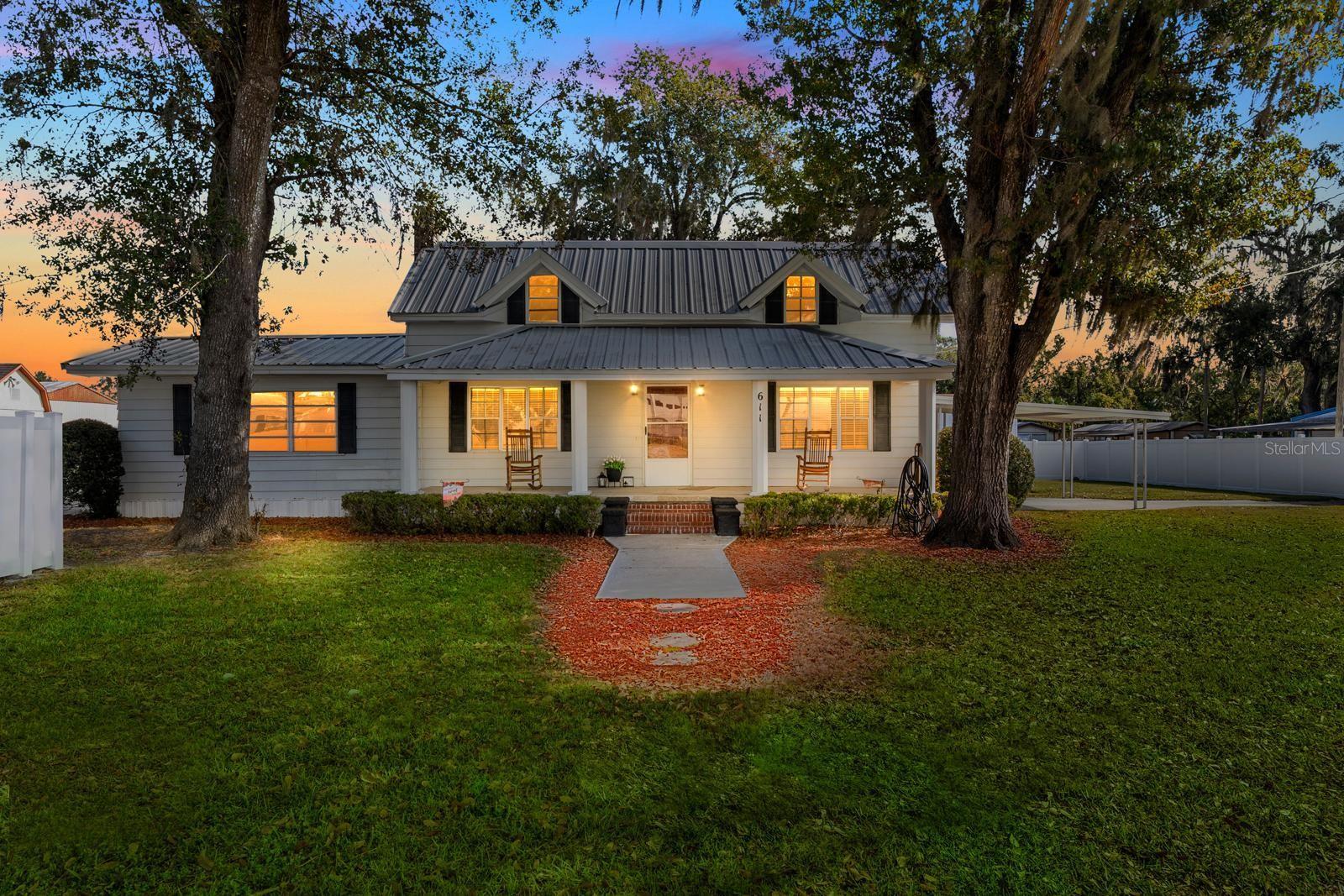 Welcome to this adorable, historic, two-story Plant City home on just over half an acre, built in 1905!  Feels like country living, but just a 3-minute drive to Interstate 4...and a 15-minute drive to Interstate 75.  No HOA. No CDD.  The front porch faces west and spans 28' across, plenty of room for a row of rocking chairs to relax with a favorite beverage and watch the sunset each evening.  The structure of this home is solid, it's been standing tall for 120 years!!  Plus...there's a NEW METAL ROOF (2019) - NEW HVAC (2022) - NEW WELL PUMP (2021) - Four-Point Inspection performed in 2021 and all agents can access it in the MLS.  The interior of the home is very inviting and features FRESH PAINT (2025), updated 5-1/2" BASEBOARDS, and A LOT of storage space!  The UPDATED KITCHEN includes a beautiful white FARM SINK, newer cabinets and countertops, new backsplash, and newer appliances.  The extra-large range features a second oven and an overhead range hood. The lighting is updated, and there’s now an over-the-sink light and an updated faucet as well. A large storage closet near the kitchen doubles as a large walk-in pantry!  The large bedroom downstairs features a walk-in closet, a BUILT-IN ELECTRIC FIREPLACE, updated LVP FLOORING, new lighting, new window blinds, a brand new BARN DOOR on the closet, and an access door to the full bathroom. The living room features an electric fireplace, updated 5.5" baseboards, new window blinds, new lighting, and a large picture window that overlooks the front porch.  Adjacent to the living room is the dining room with LVP flooring, new lighting, new window blinds, and updated 5.5” baseboards.  This room could also be used as a second living room. Also downstairs, is the full bathroom which features a tiled walk-in shower with grab bars and a built-in bench, tile flooring, new lighting, and an updated vanity sink and faucet.  You’ll LOVE the bathroom walk-in closet too!  Between the bathroom and the kitchen is an enormous utility room that could be used as an additional bedroom...or it could be remodeled into a second bathroom.  Up the newly renovated staircase are two bedrooms with windows that look out to the front yard, and both bedrooms have a walk-in closet.  The yard is very spacious and open, a blank slate for anything your heart desires....a garage, an RV garage, a large workshop?  There's NO HOA!  The home is conveniently located near shopping, dining, entertainment, and only 6 minutes from the brand new BAYCARE HOSPITAL on North Park Road.  Come see this classic beauty before it's gone.