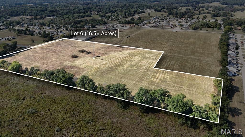Prime 16.5+/- Acre Site in High-Growth Lincoln County! Ready-to-Develop—The Perfect Canvas for Your New Commercial, Retail, or Multi-Family Development. 
Your search for a shovel-ready development site ends here. This commercial parcel is perfectly positioned in a rapidly growing area of Lincoln County, offering good access and visibility. Surrounded by over 5,000 existing homes within the Troy School District, the site guarantees immediate demand for your project. All utilities are available, significantly streamlining your construction timeline. Secure superior exposure with Hwy 47 road frontage. The site is part of a successful 41+/- acre development anchored by national names like Casey's General Store and Dollar General. It's ideal for developers targeting the thousands of families in the surrounding area. Priced attractively at $57,900 per acre, this is the prime setting to expand your footprint in Lincoln County. Sale will be based on actual survey and acres; you have the flexibility to increase or decrease the size of this lot.