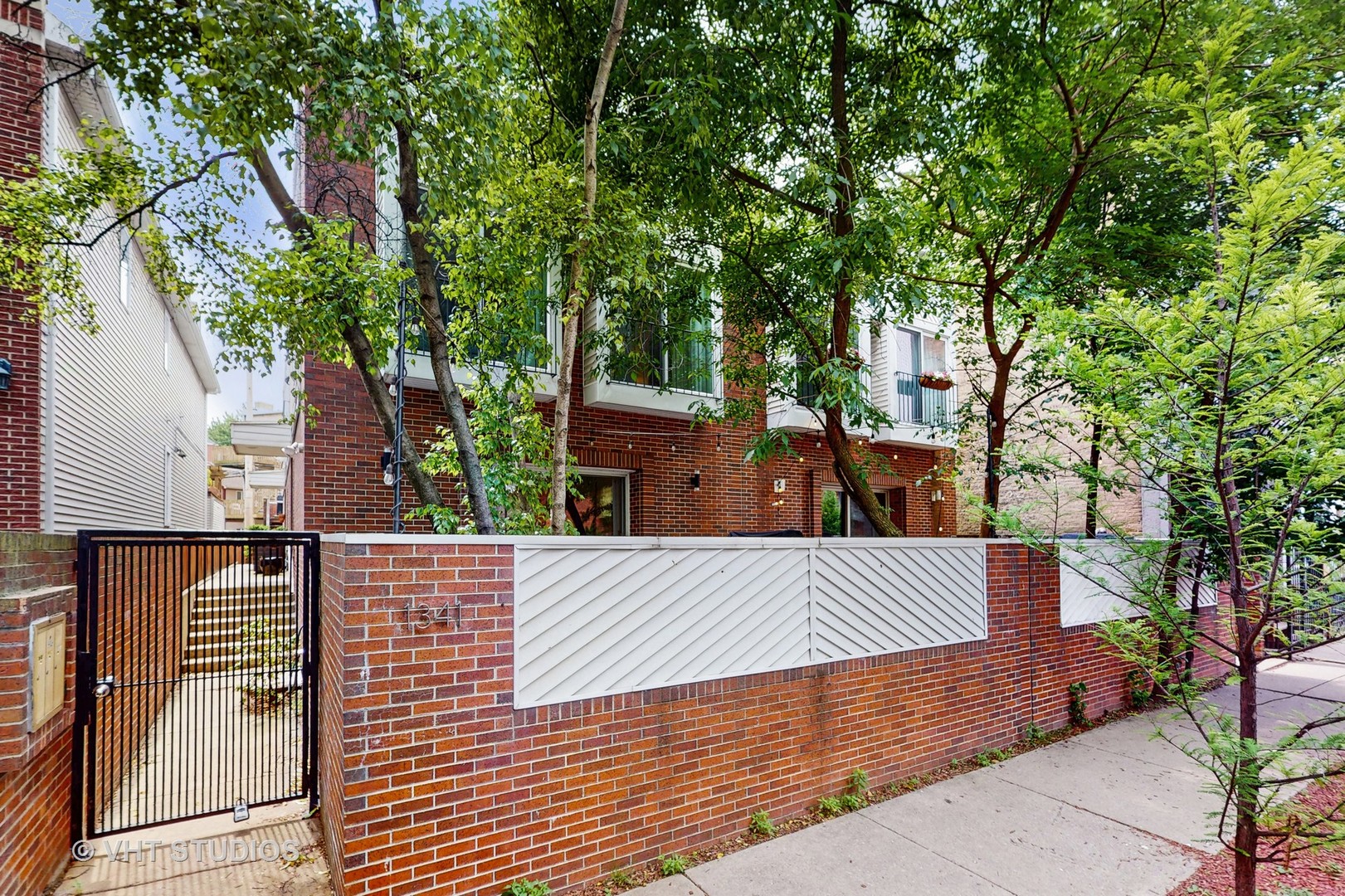 Amazing Wicker Park Townhome: Urban Oasis with No HOA!  Discover this exceptional 3-bedroom, 3-bathroom townhome in the heart of Wicker Park, offering the spaciousness and privacy of a single-family home without the burden of an HOA. Perfectly situated, you're just steps from the Blue Line, the scenic 606 Trail, and the vibrant shops and restaurants along Division and Damen.  This custom-designed, three-level residence boasts a seamless blend of modern character and clean lines. The main level features an open-concept living and dining area, highlighted by a wood-burning fireplace and beautiful hardwood floors. The gourmet kitchen is a chef's dream, equipped with stainless steel Bosch appliances, crisp white cabinetry, and elegant quartz and marble finishes. Step outside from the living room to a charming garden patio, perfect for al fresco dining.  The lower level provides additional living space with a comfortable family room, a full bathroom, laundry facilities, a dry bar, a wine cooler, and ample storage. On the upper level, the serene primary suite offers a private escape with a luxurious en-suite bathroom featuring custom Carrera marble finishes, a private commode, double sinks, and a refreshing rain shower. Two additional bedrooms, currently utilized as a guest suite and home office, share a well-appointed full hall bathroom.  Enjoy breathtaking city views and unparalleled entertaining opportunities from your expansive private roof deck, complete with durable Trex flooring and integrated planters. The home is bathed in natural light, capped by a brilliant skylight, and offers excellent closet and storage space throughout. A deep one-car garage provides extra storage. This is truly a perfect urban sanctuary!