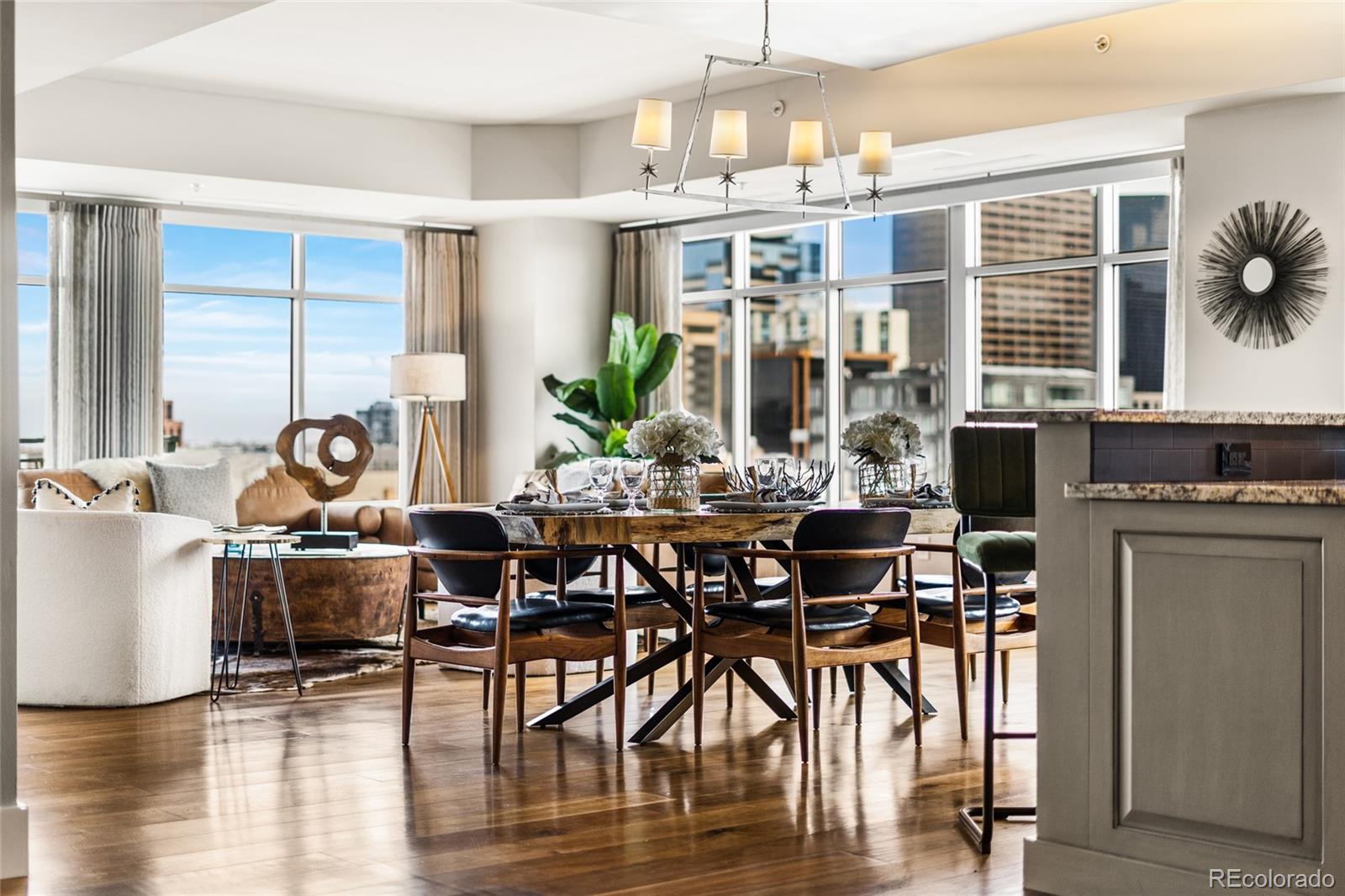 Elevated above the energy of downtown, this exceptional luxury residence delivers panoramic views of the Denver skyline and the Rocky Mountains from not one, but two private balconies. Windows frame breathtaking sunsets, sparkling city lights, and snowcapped peaks, a true front row seat to the best of Denver. Designed for both refined entertaining and everyday comfort, this 2-bedroom, 3-bathroom, plus an office home offers two spacious suites, each capable of serving as a primary retreat. The main primary ensuite is a spa-like escape featuring a steam shower and elevated finishes throughout. The chef’s kitchen is appointed with premium Miele appliances, sleek cabinetry, and thoughtful design details. A dedicated coffee and drink bar with a Sub-Zero beverage refrigerator adds an extra touch of luxury for hosting. Remote-controlled window shades, in-unit washer and dryer, and impeccable craftsmanship throughout ensure effortless living. High end wool carpet in bedrooms, custom lighting, built-ins, and a stunning custom marble fireplace create warmth and sophistication at every turn Enjoy the convenience of two private garage parking spaces, a storage unit, a fitness center, and the security of a well appointed building. And the location? Truly unbeatable. Just steps to Denver’s most iconic destinations including Union Station, Riverfront Park, Ball Arena, Larimer Square, 16th Street, Coors Field. Plus, the city’s best restaurants, cafés, and shopping. This is downtown Denver luxury living at its finest, where views, location, and design align.