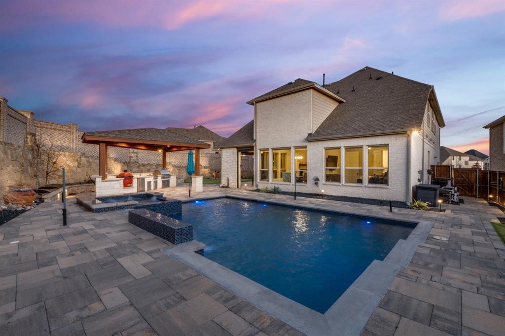 WOW! IF YOU'RE ON THE HUNT FOR AN AMAZING REAL ESTATE OPPORTUNITY, YOU'VE JUST FOUND IT! This home truly stands out, & we'd love for you to explore the detailed list of upgrades & check out the video. Come experience first hand this wonderful property for yourself. An exquisite & opulent North facing residence graced with a stunning backyard, nestled within the prestigious Estancia Addition, mere moments from the DFW Airport in the distinguished enclave of Las Colinas. This splendid abode offers an exceptional floor plan, encompassing four bedrooms, four full baths, an office, a game room, & a media room, all designed to perfection. The home's interior is adorned with quartz countertops, extending to the primary bathroom, complemented by 8-foot solid panel doors, a tankless water heater, & a gas fireplace embellished with floor-to-ceiling decorative tiles, all enhanced by cutting-edge smart home features. The kitchen, a culinary masterpiece, showcases an expansive quartz island, upgraded appliances including ovens & gas cooktops, modern lighting, ceiling-height lit cabinetry, a farmhouse sink, & a vent hood. The primary bath is a sanctuary of luxury, featuring a glass shower with tile inlay, dual sinks, & a spacious walk-in closet. Ascend to the upper level to discover a grand game room featuring a wet bar, a private media room, & three bedrooms, accompanied by a Jack-and-Jill bath & an additional full bath adjacent to the fourth bedroom. The backyard is a haven of tranquility, featuring heated & chilled pool & spa resting on helical piers, accompanied by an outdoor fireplace. The meticulously landscaped yard also features custom lighting, outdoor kitchen, a pergola, Belgard pavers, a covered patio, Zoysia grass with French drains, & more. Further features include a Generac whole home generator, custom motorized blinds, bespoke mirror frames, an Ecosystem whole home water softener & filtration system, wine station, custom wet bar & sink.