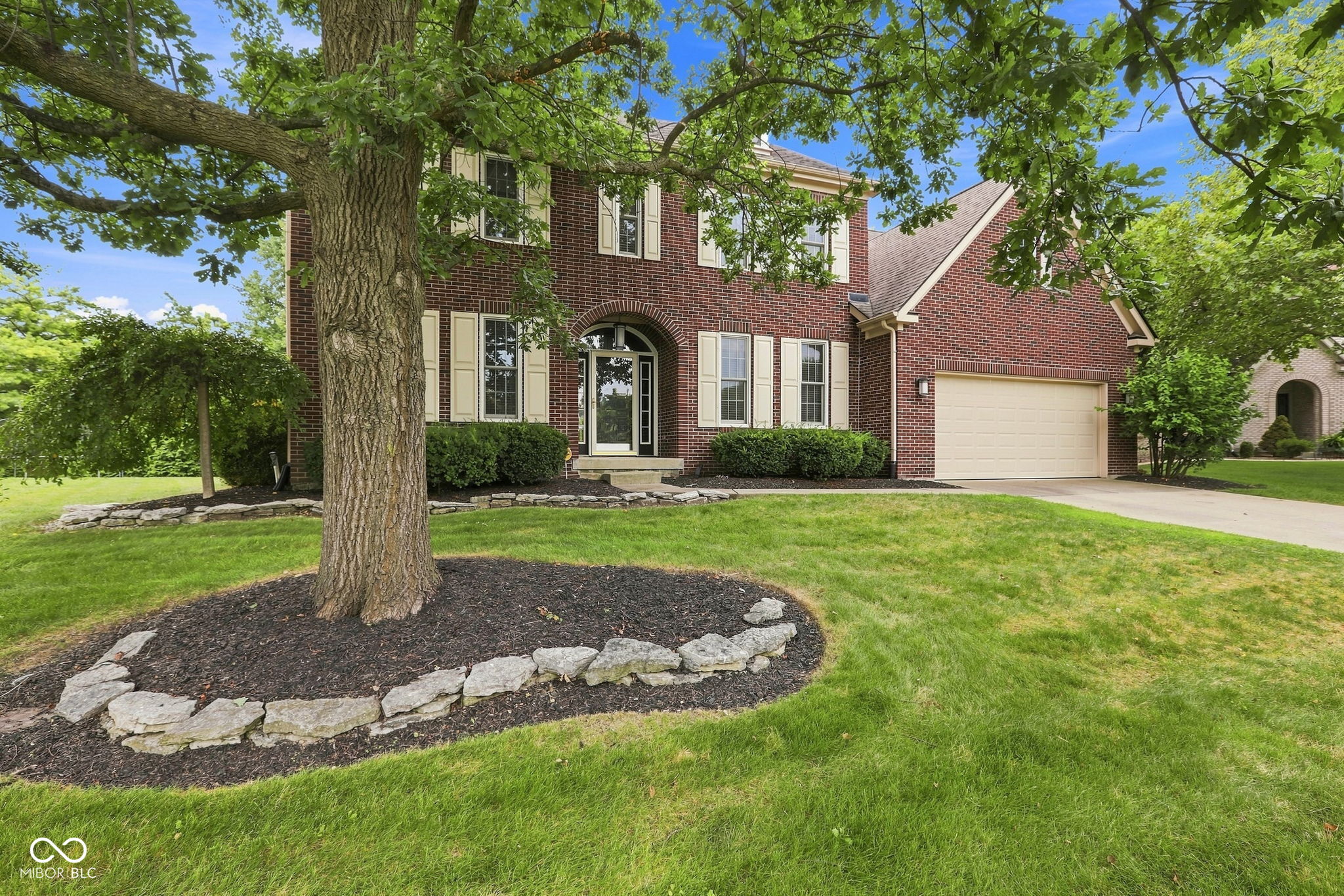 What if the home you've been waiting for wasn't brand new...it was simply better? Tucked away at the end of a quiet cul-de-sac in Fishers' desirable Sandstone Woods neighborhood, this nearly 4,000 sf, 4 bedroom, 2.5 bath home features a finished basement and tandem 3 car garage and has been transformed with thoughtful, high-end updates that elevate everyday living. The heart of the home is a stunning, fully remodeled kitchen featuring custom cabinetry, quartz countertops, stainless steel appliances, an oversized island, custom beverage center, and a beautifully redesigned mudroom and laundry room. The main level also features engineered hardwood floors, a private home office, formal dining room, new carpet in the living room, and a striking two-sided fireplace flanked by custom built-ins. Just as impressive, the completely reimagined primary suite offers a spa-inspired bath with a curbless designer tiled shower, freestanding soaking tub, custom dual-sink vanity, and two walk-in closets with custom organization systems. Upstairs, four spacious bedrooms and a cozy loft provide flexible living space, while the finished lower level with new luxury vinyl plank flooring is ready for recreation, fitness, hobbies, or entertaining. Outside, mature trees frame the large fenced backyard where a custom covered patio, open paver patio, and fire pit with flagstone seating area create an outdoor retreat you'll enjoy for years to come. A finished tandem three-car garage, abundant storage, new water heater, irrigation system, and extensive updates throughout complete the package. With direct neighborhood access to Brooks School Park and just minutes from top rated Hamilton Southeastern Schools, Geist Reservoir, The Yard, Topgolf, Hamilton Town Center, the Fishers Community Center, shopping, dining, and entertainment, this home offers an exceptional combination of location, lifestyle, and quality rarely found at this price point. Experience it in person today!