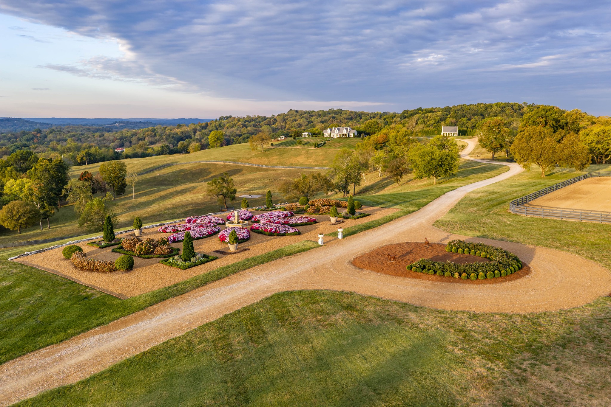 Welcome to Daisy’s Folly, an extraordinary 397-acre Middle Tennessee estate distinguished by European architectural influences, exceptional craftsmanship, and premier equestrian facilities. Meticulously developed, the property combines refined country living with extensive agricultural improvements. The primary residence features 150- to 200-year-old European windows and doors, custom English plumbing fixtures, reclaimed ceiling beams and wood plank flooring. With 5 bedrooms, 4.5 baths, and beautifully appointed living and dining spaces, the home opens to 1,200 sq ft of covered porches with sweeping countryside views. At the heart of Daisy’s Folly stands a 7,500 sq ft equestrian stable blending traditional craftsmanship with modern functionality. Cathedral ceilings and crystal chandeliers distinguish the space, which includes seven stalls, grooming and wash areas, and tack facilities. Expansive paddocks and riding arena complete the equestrian amenities. The finished 2,500 sq ft upper level features a 1-bedroom apartment with full bath, office, entertainment area, and game room with bar.  Among the estate’s most distinctive features is an exquisite replica of a 17th-century English chapel set amid 2 acres of beautifully landscaped grounds, showcasing custom stained glass windows, reclaimed ceiling beams and flooring, and thoughtfully crafted architectural details. Additionally, the property includes a 5,000 sq ft utility barn with a finished 2-bedroom 2-bath apartment and separate 2,200 sq/ft farm staff housing. An estate of remarkable character and enduring beauty, Daisy’s Folly is a truly exceptional offering in the heart of Middle Tennessee.