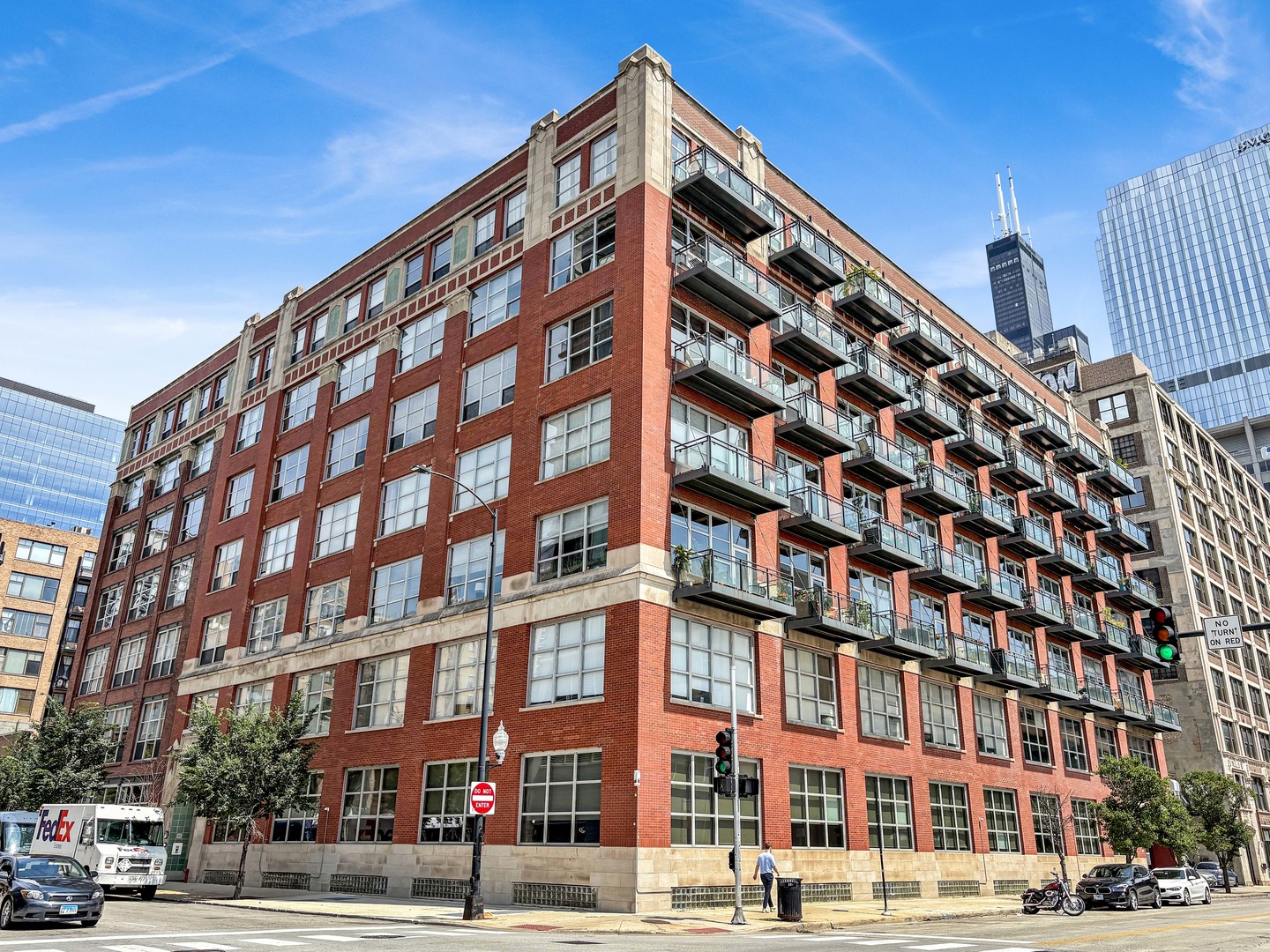 This brick-and-timber loft in a converted West Loop building spans over 1,000 feet! The unit offers 11-foot, wood-beam ceilings topping an open living room/kitchen that includes a gas fireplace, a wall of windows and a balcony.   The kitchen includes an island large enough for three-to-four bar stools, stainless steel appliances and a new garbage disposal. There's enough room for a dining table, a desk and any size sectional. The bathroom has fresh paint, includes a bathtub and offers storage in the vanity. The laundry room also has storage space, in addition to an on-site storage locker.   The carpeted bedroom will hold any size mattress, currently housing a king, as well as a home office. The room is lofted while still getting light, and a wall of closets completes the space.  The well-maintained elevator building also houses a fitness center, a bike room, and a garage parking spot is included with the sale.  Best of all, the building is a 10-minute walk from some of the city's best dining on Randolph Street, groceries and outdoor spaces such as Bartelme Park. Unition Station is just down the street, and its a quick commute to Loop, the Blue Line, Metra, and 90/94. Unit is occupied by sellers, please give 24 hours notice for showings.