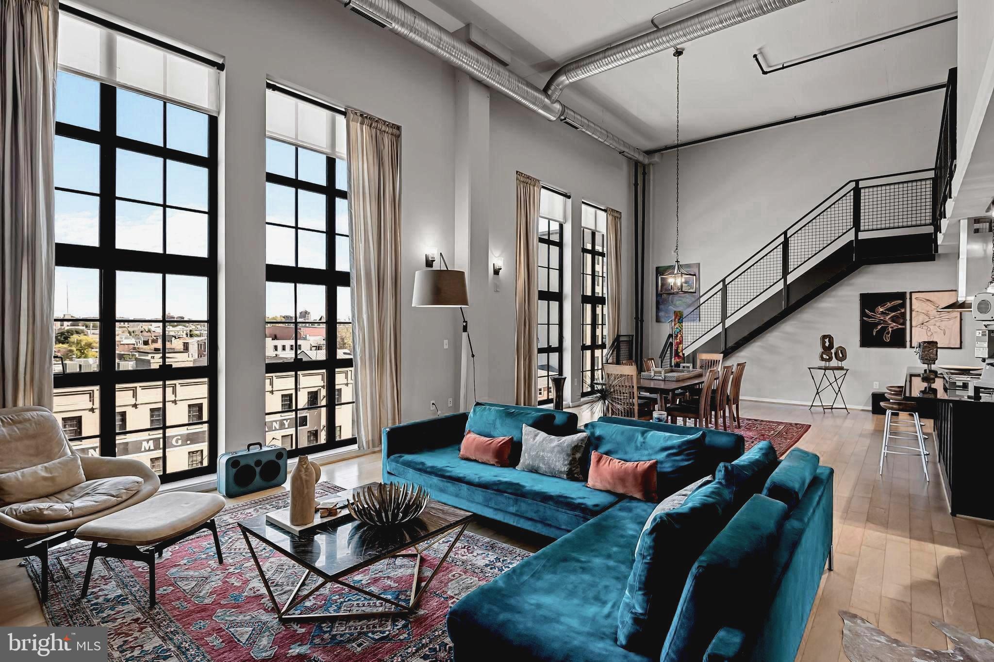 Significant price improvement on this stunning chic industrial loft condominium in the coveted Canal Street Malt House!  This extraordinary light-filled residence exudes a floor plan designed to maximize an incredible sense of openness and style. The residence features a dramatic living/dining area with 19’ soaring ceilings, a gourmet kitchen with expansive island, sleek wood cabinets, deluxe stainless-steel appliances with commercial Wolf 6 burner stove, Sub Zero fridge with icemaker, wine fridge, and dishwasher, glass backsplash, and granite countertops. Additional features and enhancements include handsome wood flooring on the main level and designer wall to wall carpeting on the mezzanine loft, 2 en-suite bedrooms/baths, an additional half bath, spacious walk-in closets, separate large laundry/utility room with front loading washer and dryer, custom window treatments, designer lighting and fans. The impressive wood and metal staircase enhances the main level contemporary open floor design. One secure assigned garage parking space conveys, and an additional storage area is provided. Spectacular views of the gorgeous cityscape can be enjoyed from the dramatic window walls of glass on the east and west end of the condo and from the generously sized, covered balcony overlooking the stunning common area courtyard and gardens. The home is enhanced with a unique blend of exposed duct work, columns, concrete, steel and wood finishes.  The building location is ideally nestled among Baltimore’s most vibrant neighborhoods and is within proximity of award-winning restaurants, Whole Foods, shopping, bars, highways, institutions, Johns Hopkins and U of M campuses, train stations, and the stadiums.