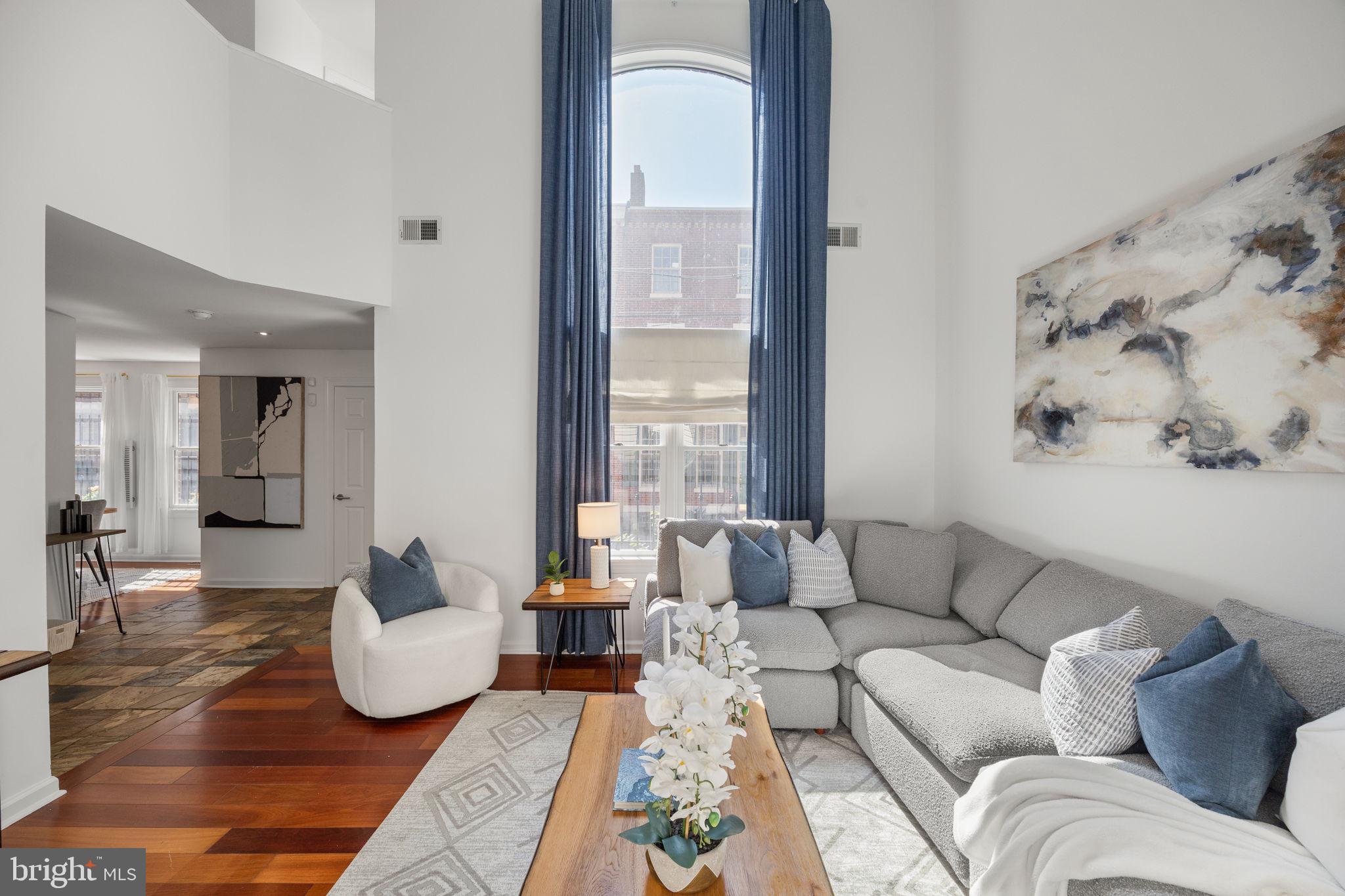 If you’re tired of cookie-cutter townhomes, 517 Kauffman Street is where you should look. This 3-bedroom, 3.5-bath home has character, tons of natural light, two outdoor spaces, and a huge renovated lower level, all tucked onto one of Queen Village’s prettiest tree-lined blocks. The main level is a “wow,” with a dramatic two-story living room featuring oversized windows overlooking quiet Kauffman Street. Sliding doors open to a private brick patio, while the dining area flows into a spacious kitchen with wood cabinetry, stone countertops, a Sub-Zero refrigerator, Monogram gas cooktop, double ovens and wine fridge, and a Miele dishwasher. A coat closet and conveniently located powder room complete the main level.Upstairs are two spacious bedrooms with custom closets and a full hall bath. The primary suite is on the third floor, with generous closet space, and an en suite bath featuring a double vanity, heated floors, and glass-enclosed steam shower. Just outside the primary is a private deck; an ideal spot for relaxing sunset drinks. The renovated lower level adds serious bonus space, with a full bathroom and plenty of room for a second living area, playroom, gym, office, or guest suite. And then there’s the location: set within the Nebinger School catchment and surrounded by neighborhood parks and playgrounds. Shot Tower Coffee, Square Pie, and John’s Water Ice are just steps away, while Royal Izakaya, Fiorella Pasta, Headhouse Square, the Italian Market, Society Hill, and Bella Vista are all within an easy walk! A parking spot is also available to rent at nearby Bainbridge Lofts.