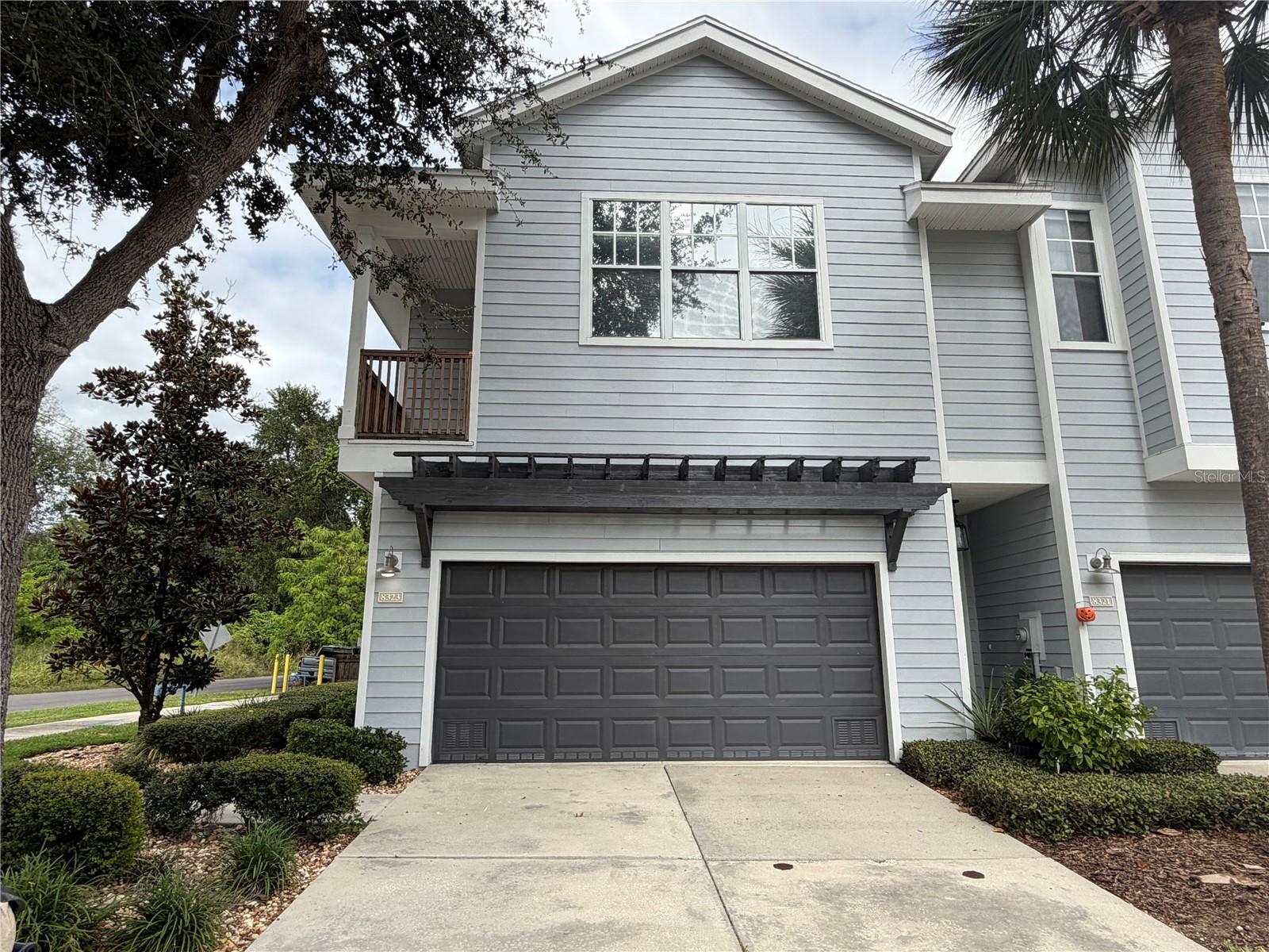 Welcome to 8323 King Blossom Court! This well-maintained corner-unit townhouse offers 1,645 square feet of living space with 3 bedrooms, 2.5 bathrooms, and an attached 2-car garage. Attractive landscaping and a welcoming entry deck create charming curb appeal, while the open-concept downstairs layout provides a comfortable setting for everyday living and entertaining.Sliding glass doors connect the living room to a rear porch and fully fenced yard, extending your living space outdoors. Pets are OK! Upstairs, you’ll find all three bedrooms plus a versatile sitting or bonus area that could also be used as an office! The primary bedroom features beautiful French doors opening onto a private balcony, a peaceful spot to unwind and enjoy the sunset. Both large guest bedrooms have spacious walk-in closets for generous storage, and a convenient downstairs half bathroom serves guests.Additional features include fresh paint, security system wiring, and plumbing for a water softener. Conveniently located for access to Tampa International Airport, shopping, dining, downtown Tampa, and area beaches, this home brings together comfort, space, and everyday convenience. Schedule your private showing today!Recent renovations include Frigidaire kitchen appliances in 2019; new A/C unit installed in 2021; and refinished front porch in 2022 as well as tinted windows to help with the Florida heat!